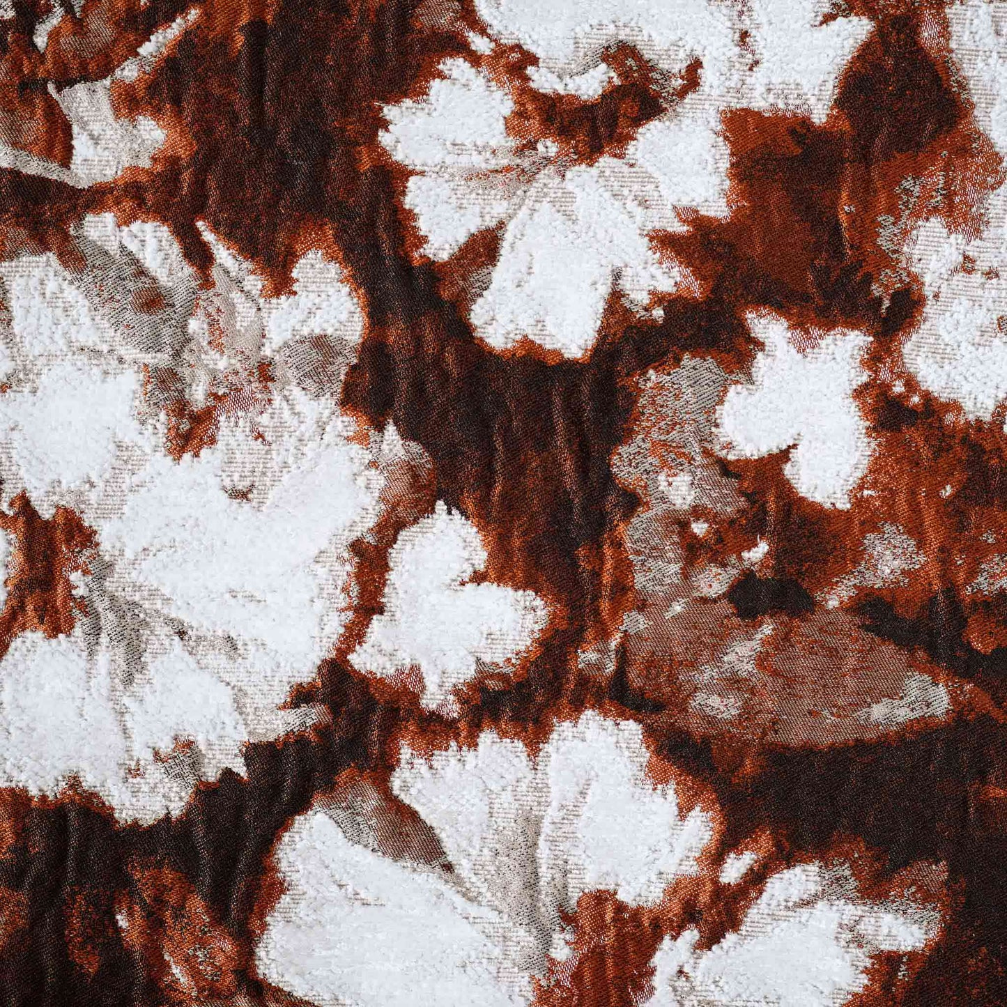 An attractive decor cushion cover adorned with red and white abstract floral.