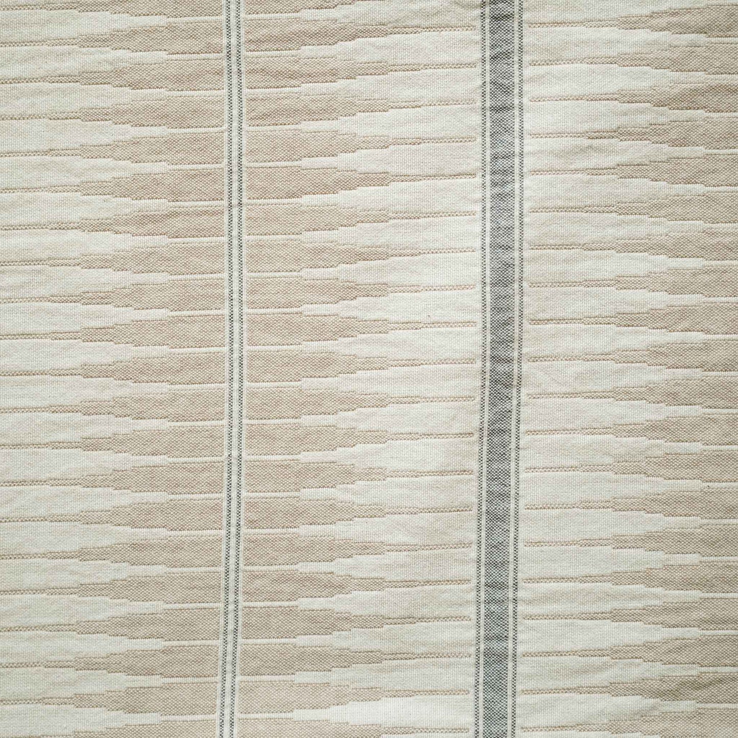 Grey and beige striped lumbar cushion have a subtle striped pattern.