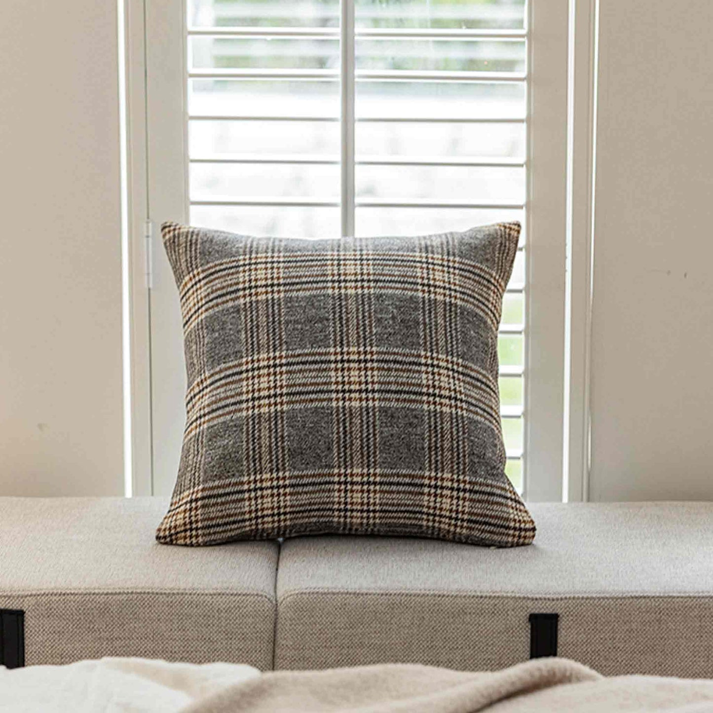 Classic brown grey plaid cushion covers with soft touch on chair.