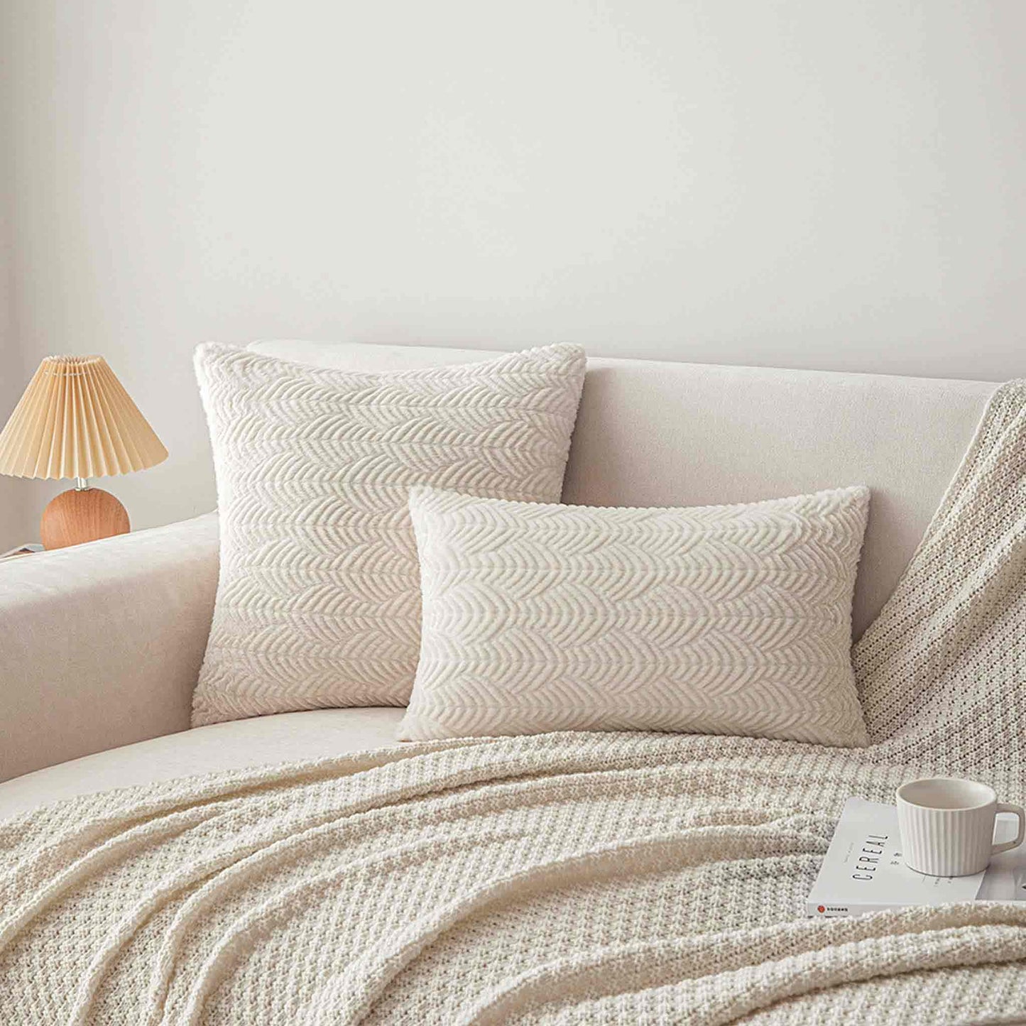 White wave cut faux fur lumbar cushion covers on sofa.