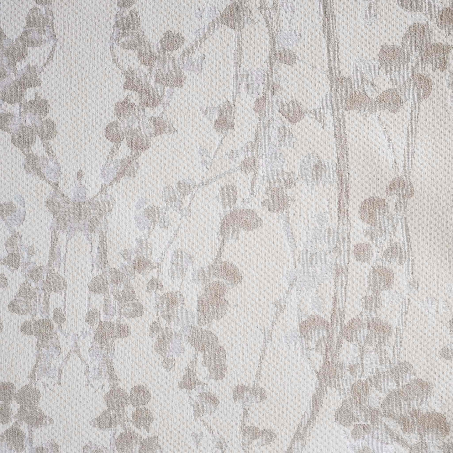 Beige chenille cushion covers with oatmeal vine pattern.