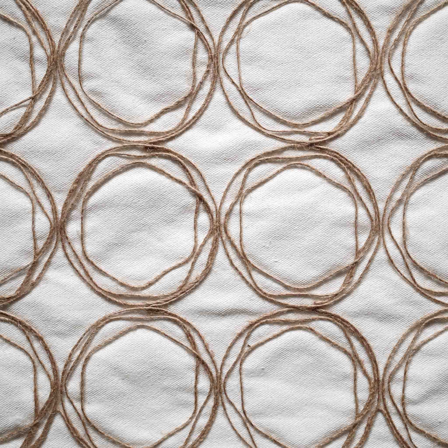 Round twine design cushion with white background adds a modern touch to home decor.