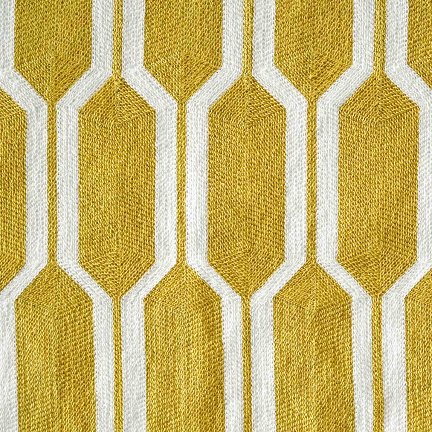 A yellow and white geometric cushion with a modern design using bold shapes and lines.