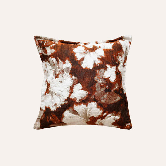 An attractive decor cushion cover adorned with red and white abstract floral.