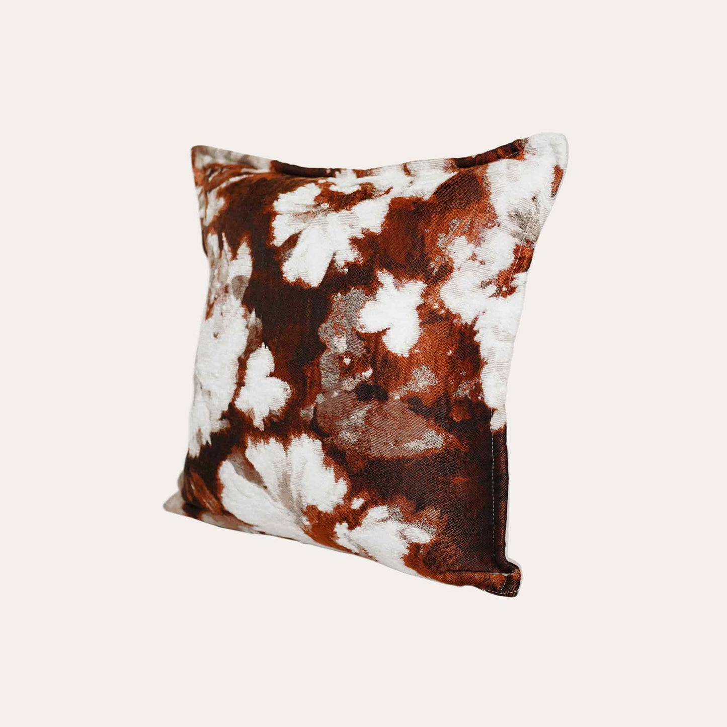 An attractive decor cushion cover adorned with red and white abstract floral.