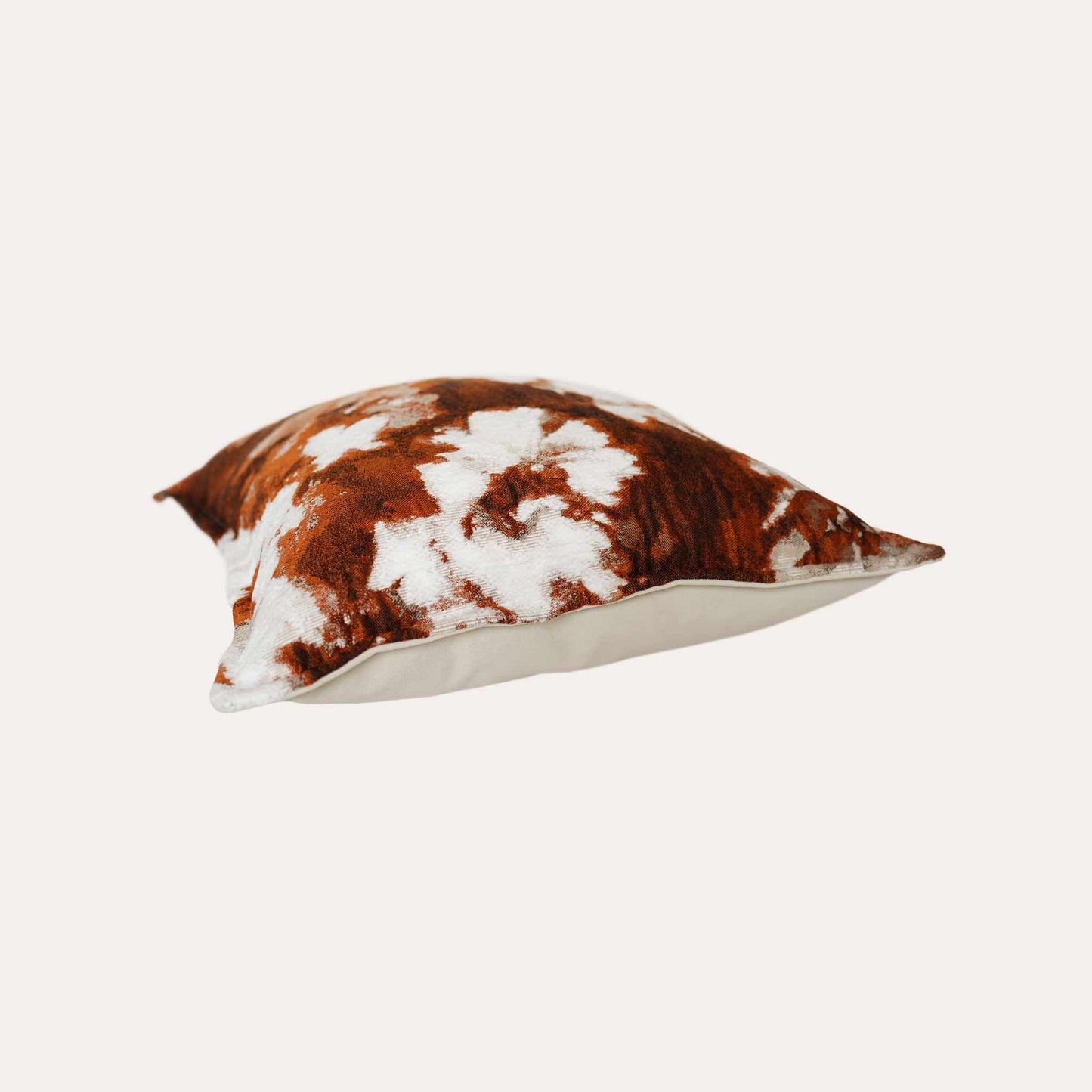 An attractive decor cushion cover adorned with red and white abstract floral.