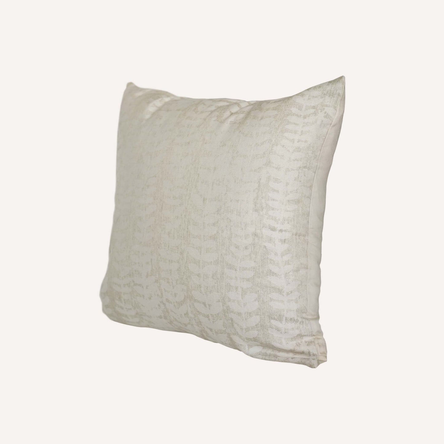 A beige cushion featuring a decorative pattern, placed on a neutral background.