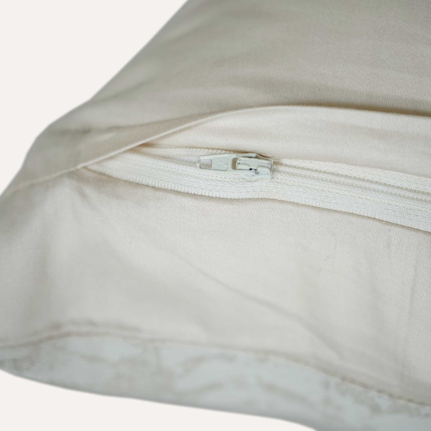 Close-up of a cushion featuring a visible zipper along one edge, showcasing its design and functionality.