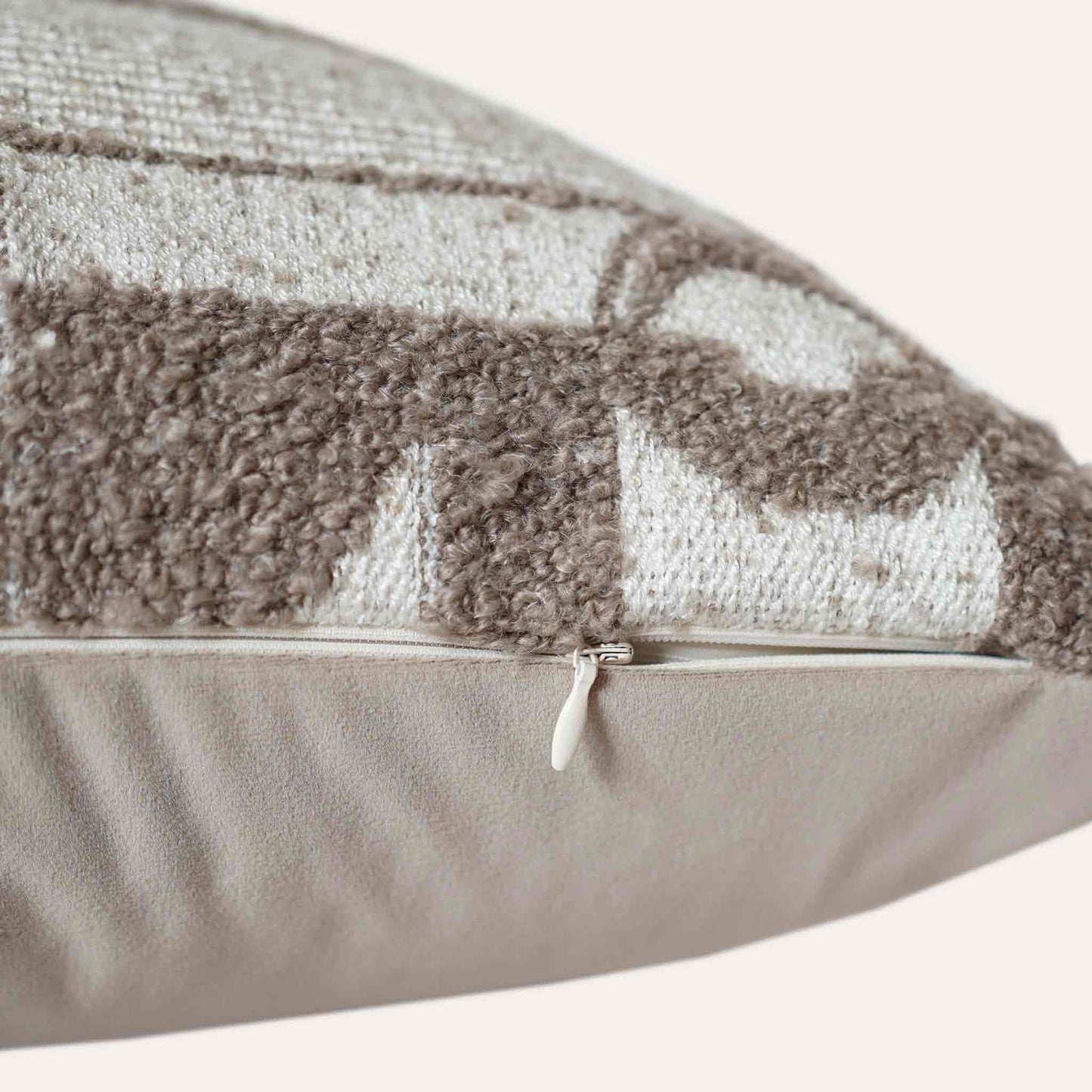 Trendy cushion cover with a chic geometric pattern in soft beige and white tones with invisible zipper.