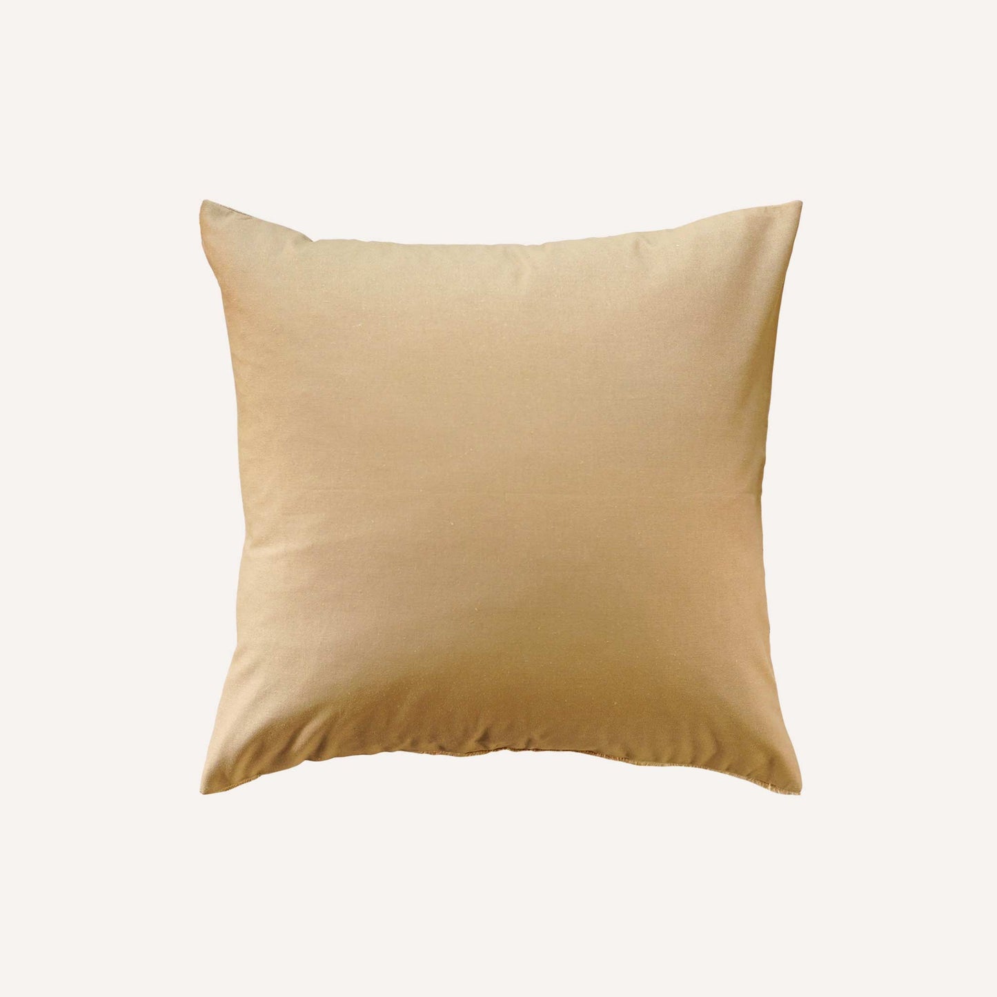 Beige cushion with a simple, unadorned design, resting on a neutral surface.