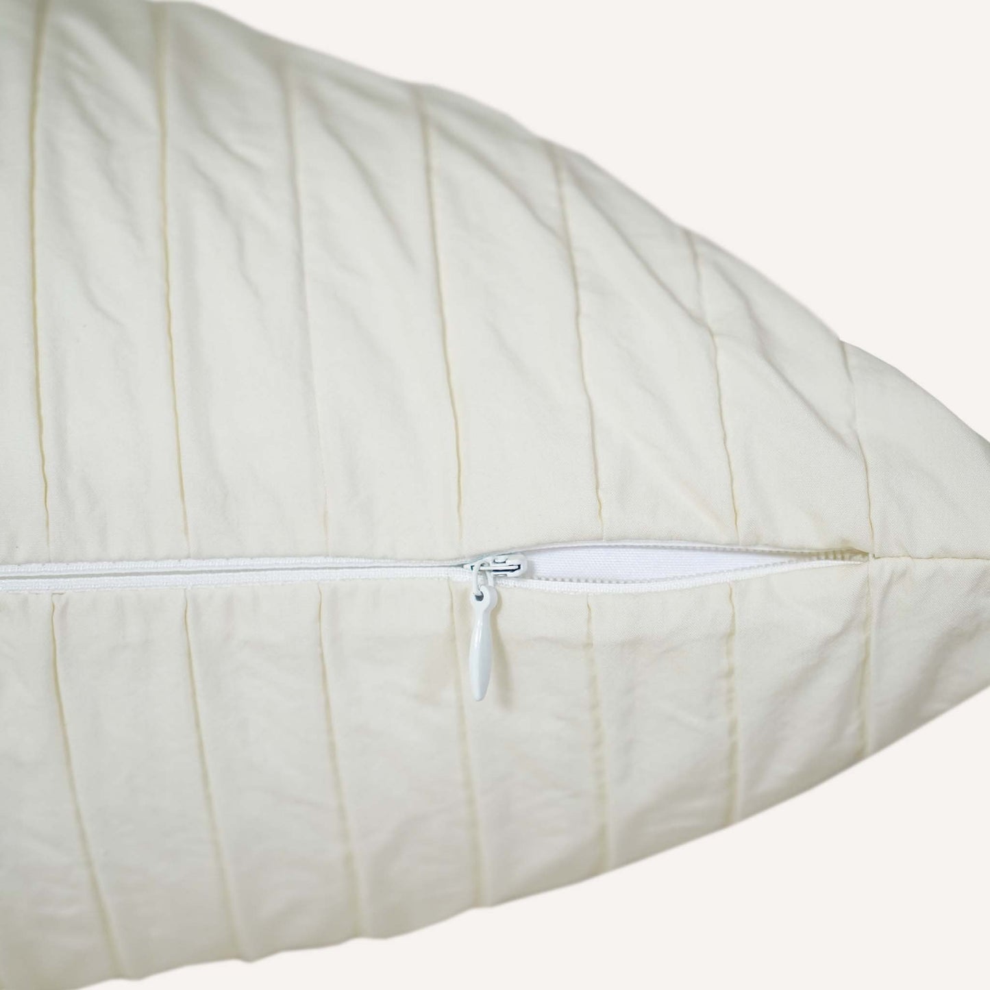 A close-up view of a cushion featuring a visible zipper along one edge.