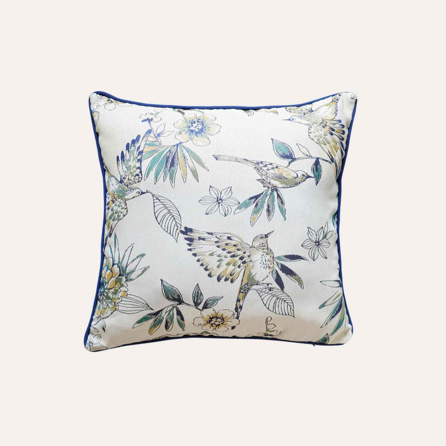A charming white and blue cushion showcasing beautiful bird and floral patterns.