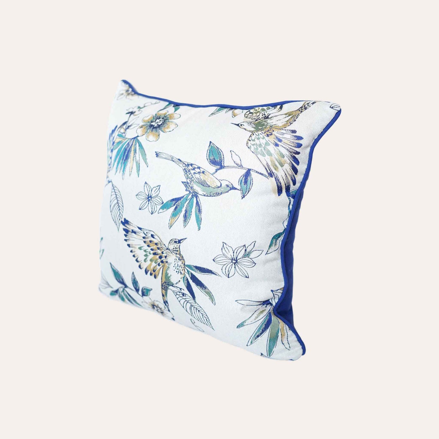 A charming white and blue cushion showcasing beautiful bird and floral patterns.