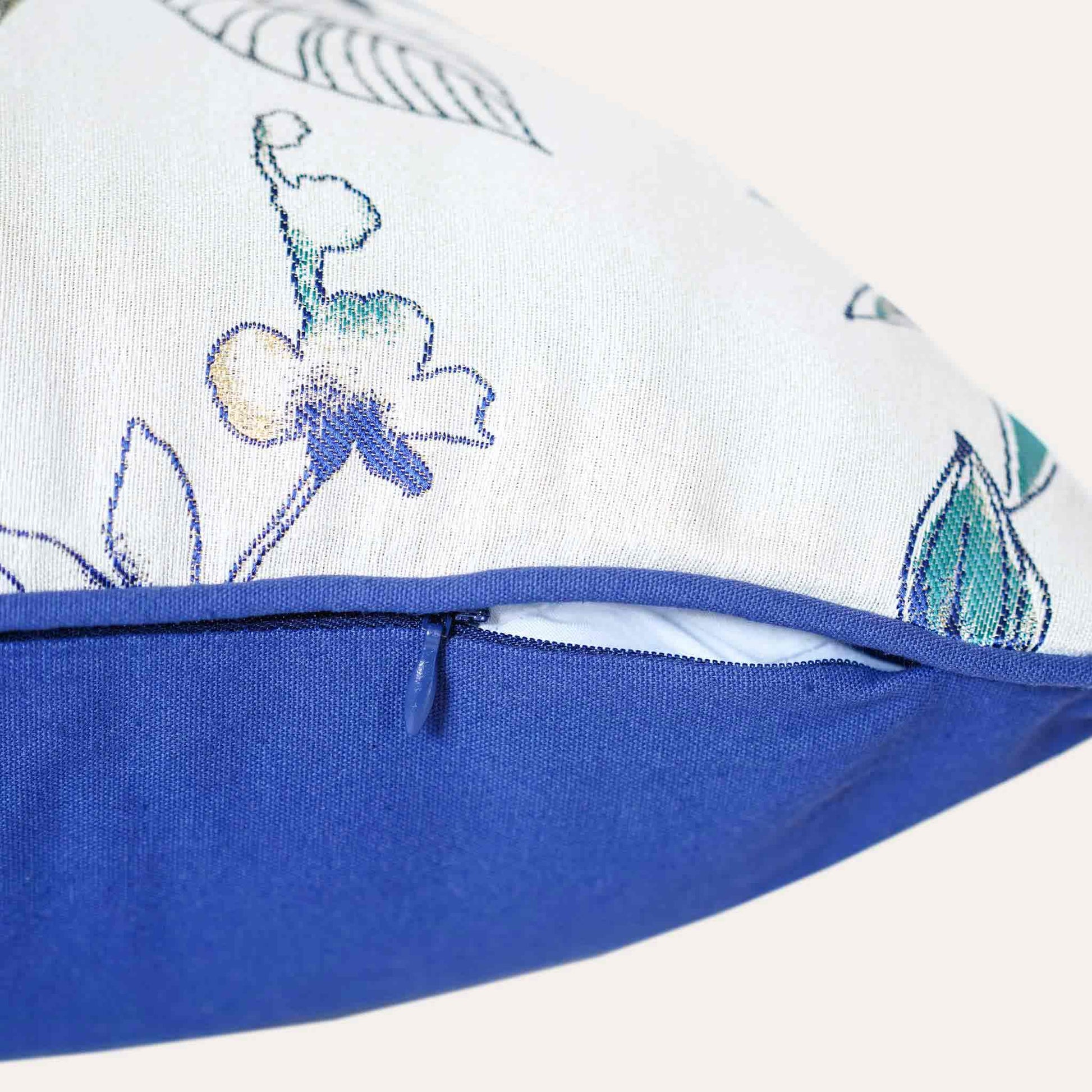 Bird and floral jacquard on white and blue cushion with invisible zipper.