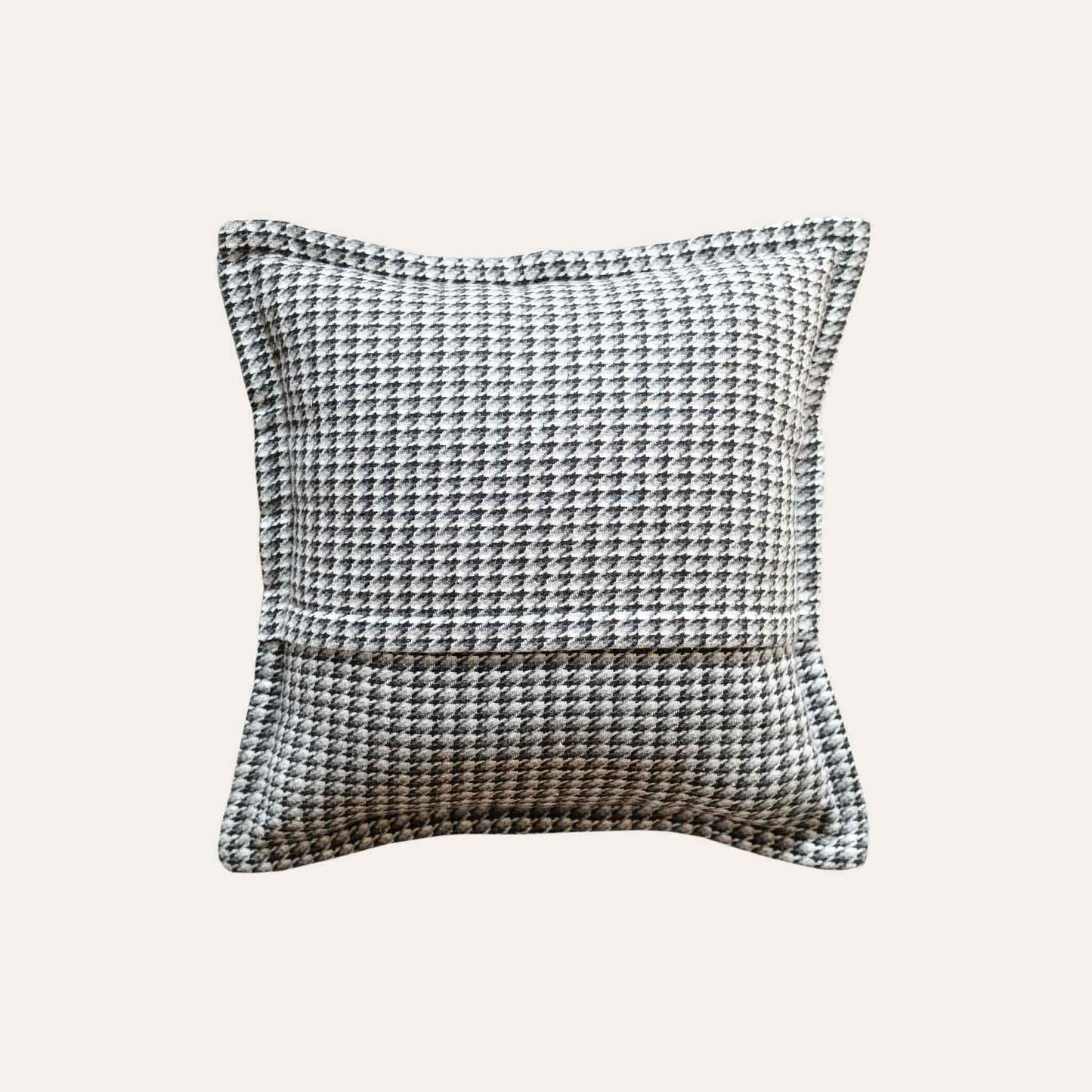 A black and grey checkered cushion cover featuring a houndstooth pattern with wide edges.