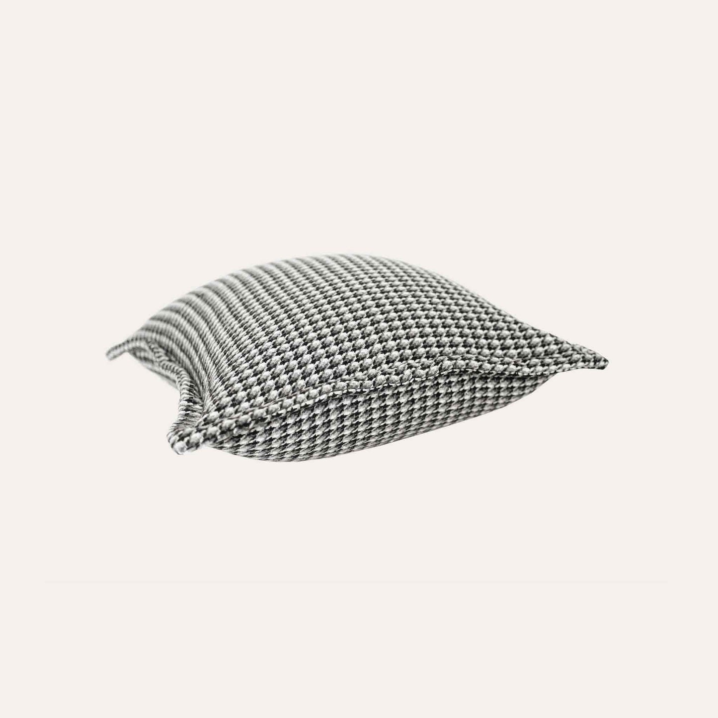 A black and grey checkered cushion cover featuring a houndstooth pattern with wide edges.