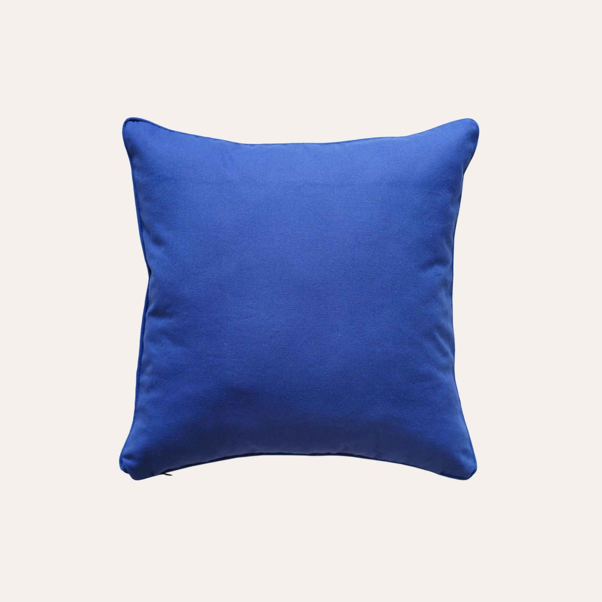 An elegance cushion cover adorned with a botanical floral design in blue and white with solid blue back.