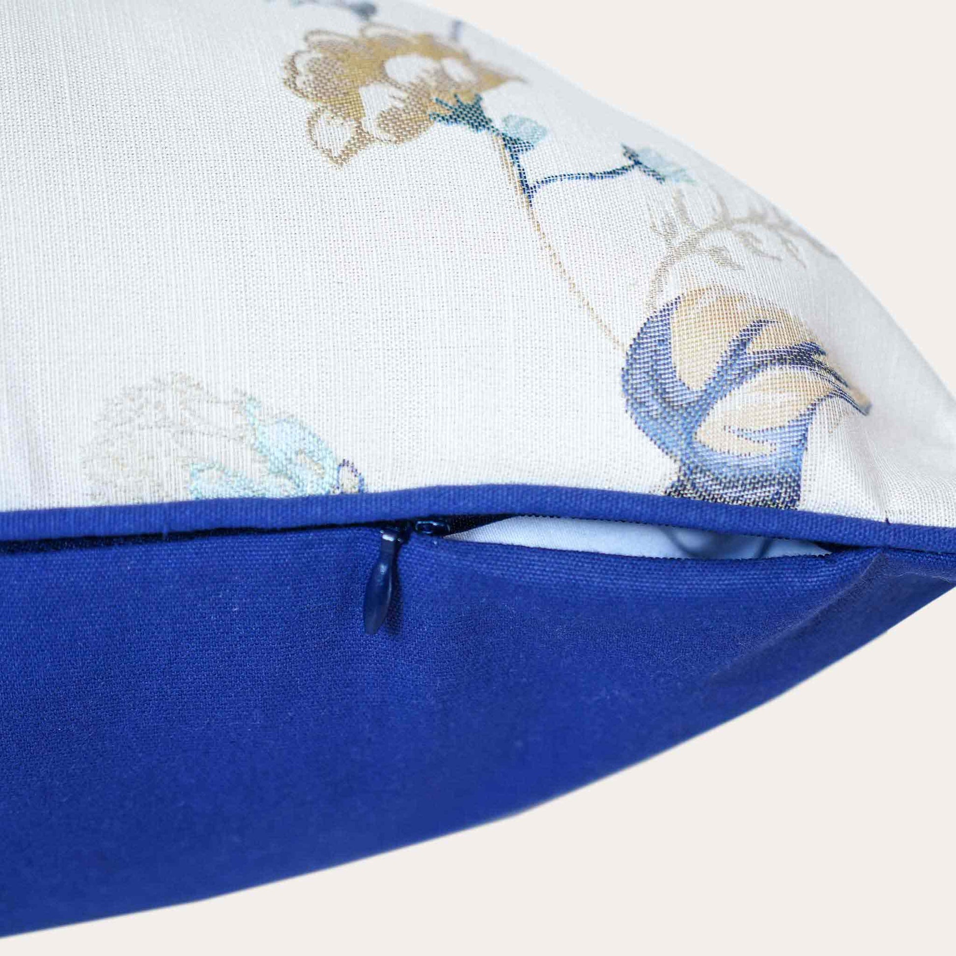 An elegance cushion cover adorned with a botanical floral design in blue and white with invisible zipper.