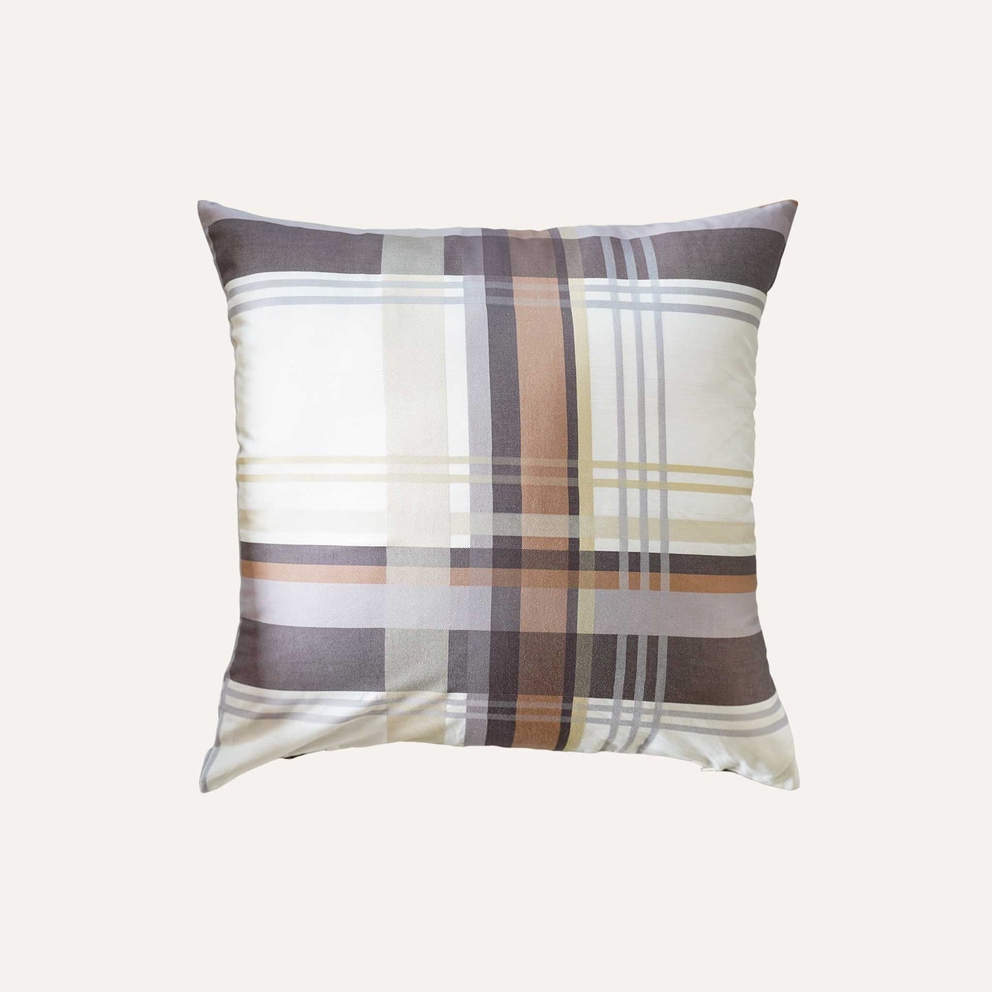 Cushion featuring a classic plaid pattern in shades of brown, grey, and white.