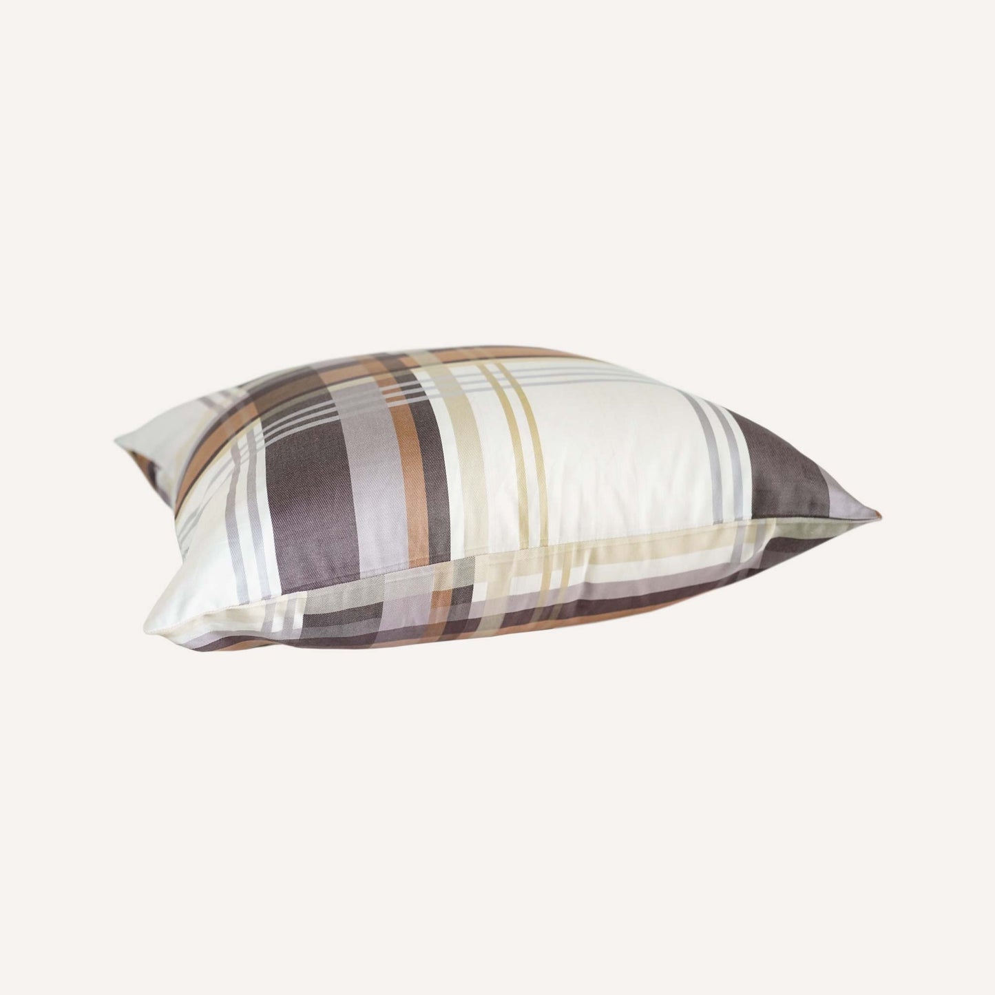 Cushion featuring a classic plaid pattern in shades of brown, grey, and white.