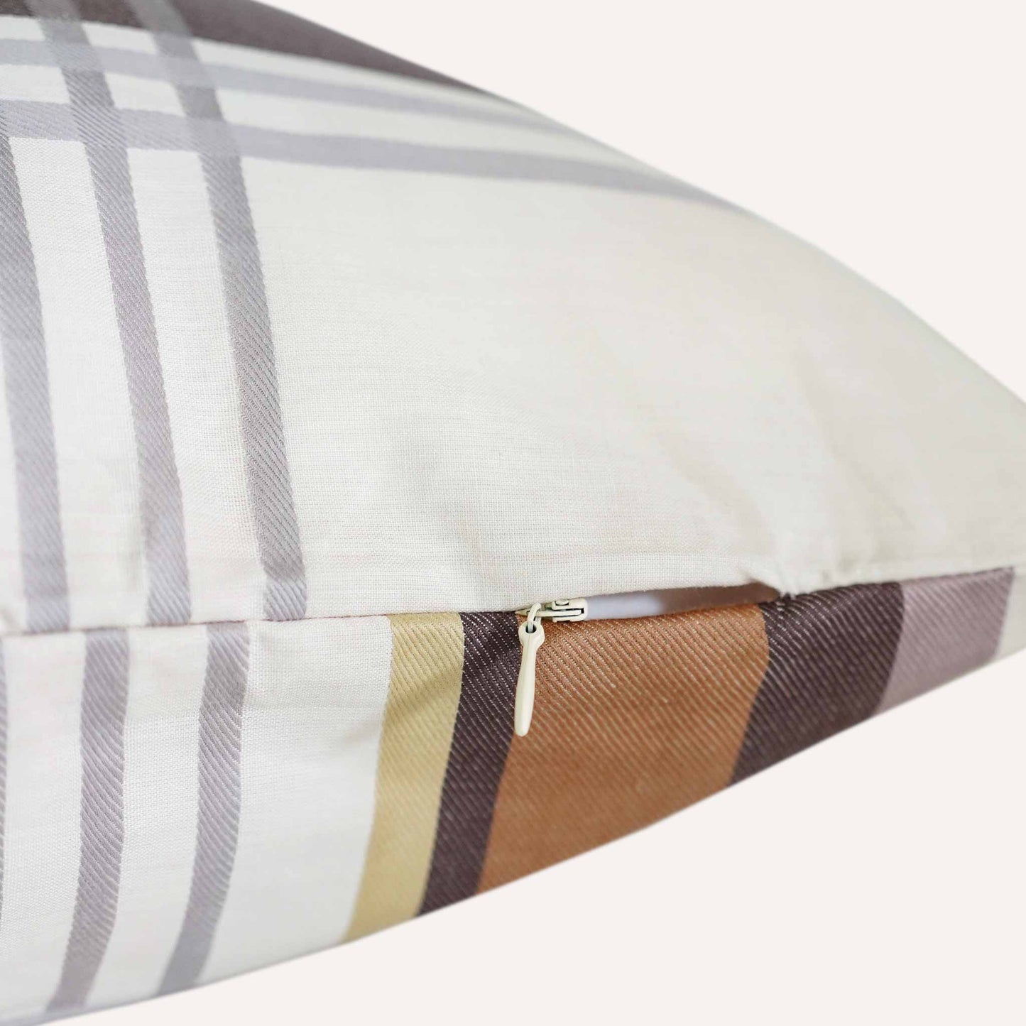 Close-up of a cushion featuring a visible zipper along one edge, showcasing its design and functionality.
