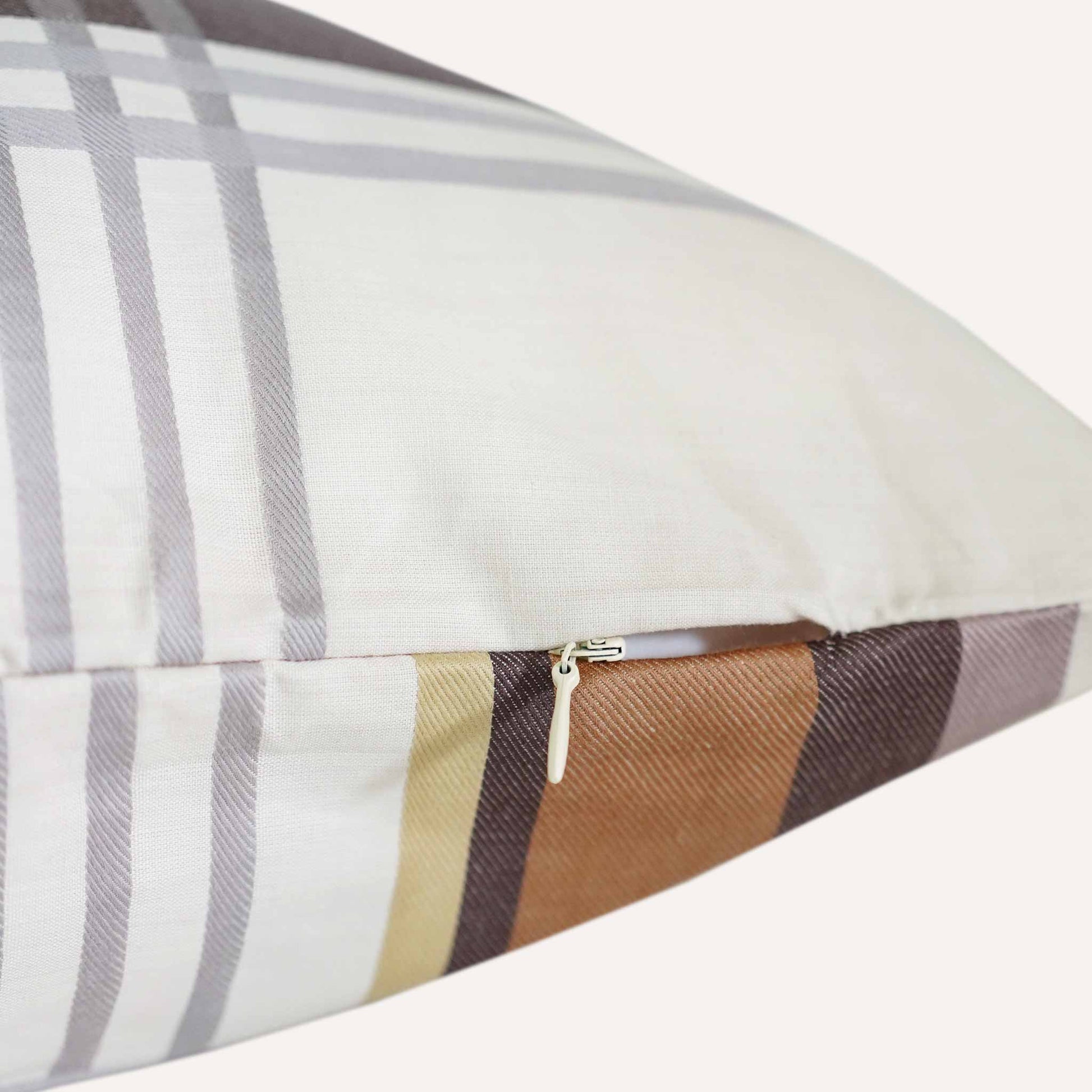 Close-up of a cushion featuring a visible zipper along one edge, showcasing its design and functionality.