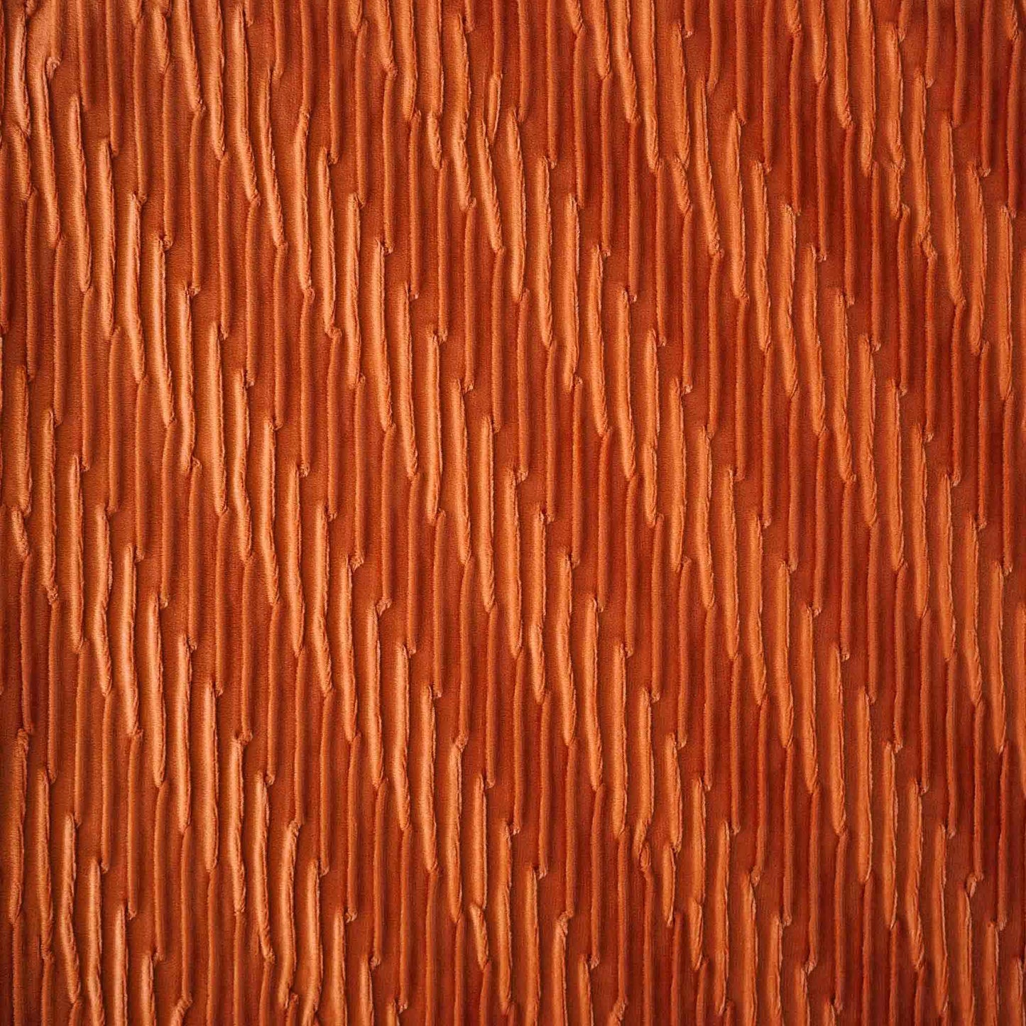 Velvet pumpkin orange cushion covers with pleated design and smooth texture.