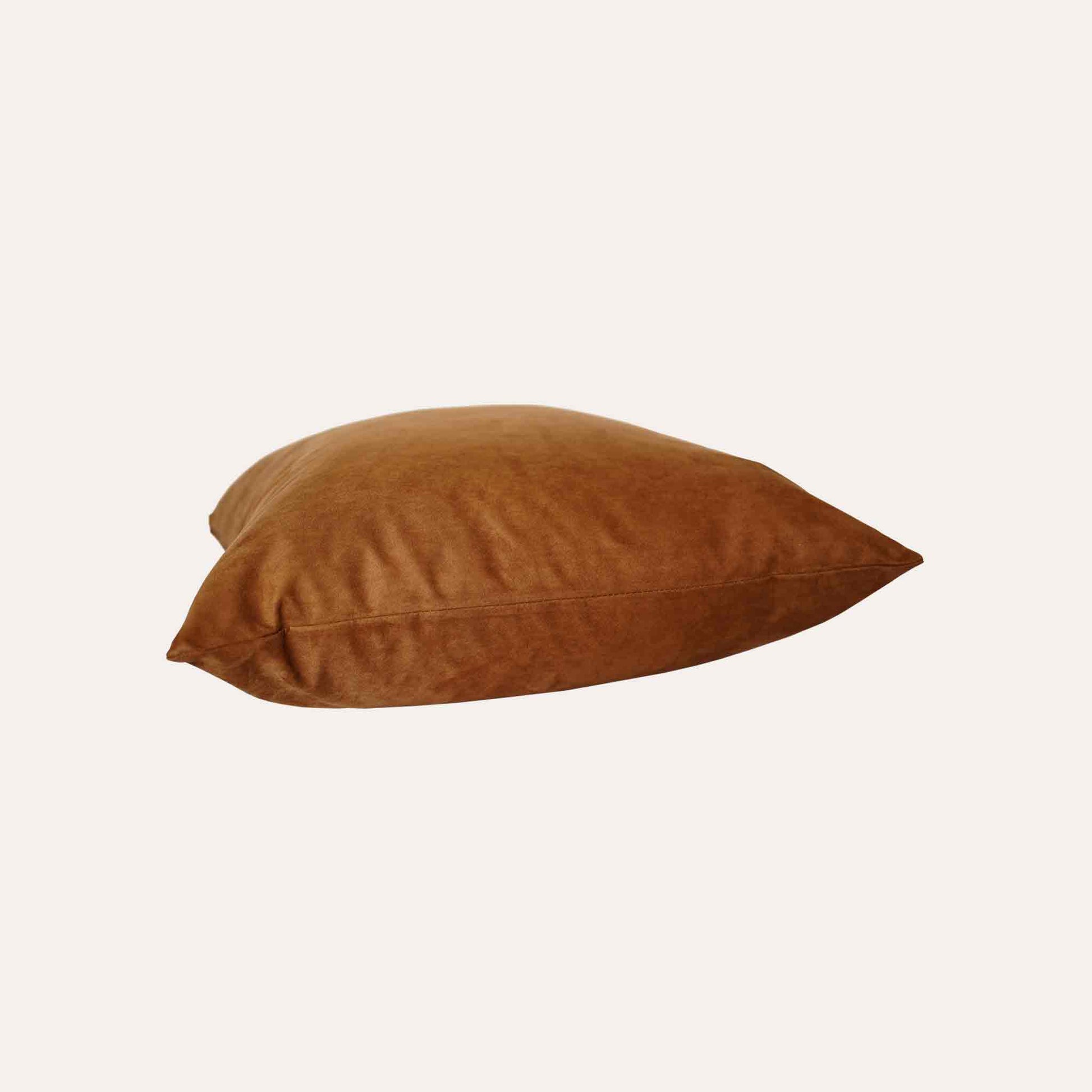 Soft texture and stylish design of solid tan suede cushion cover.