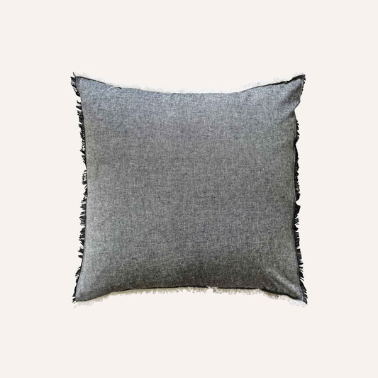 Dark Gray cushion with black fringes, adding a stylish touch to home decor.