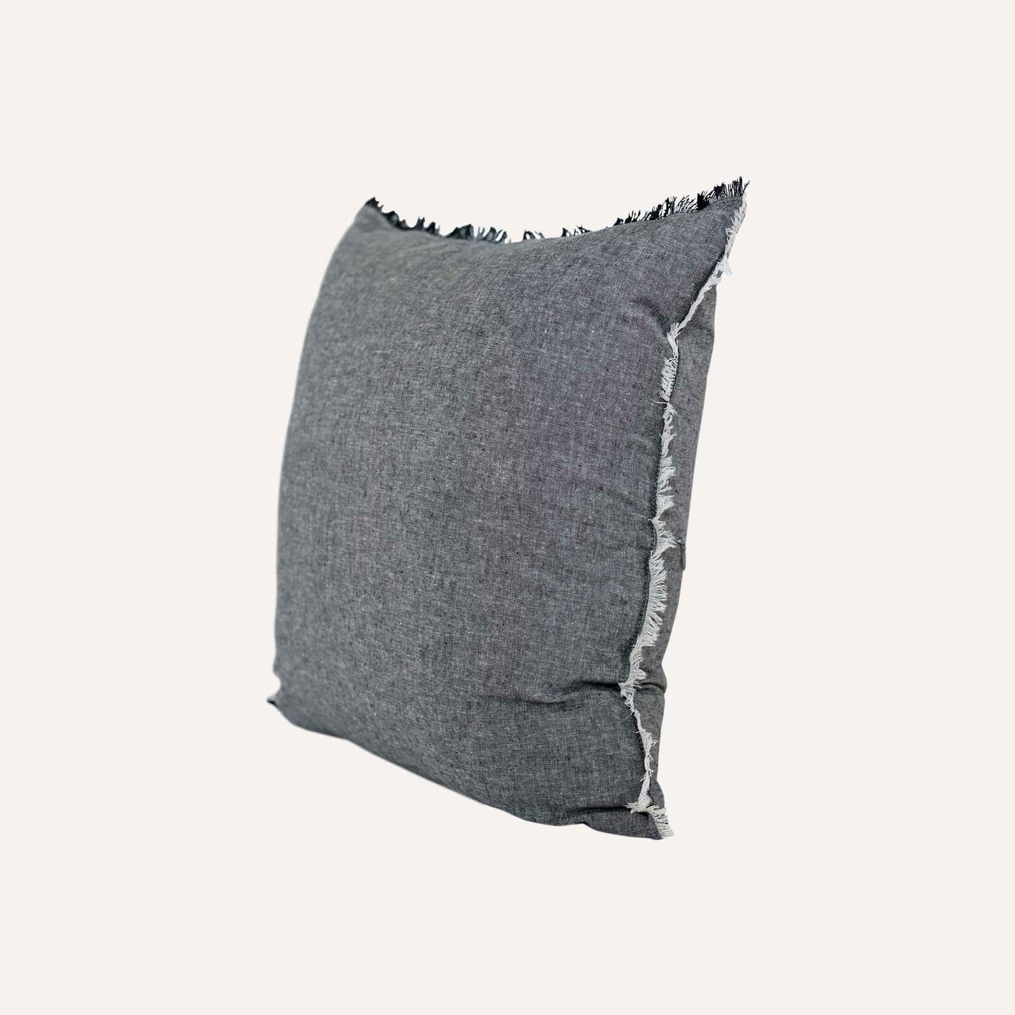 Dark Gray cushion with black fringes, adding a stylish touch to home decor.