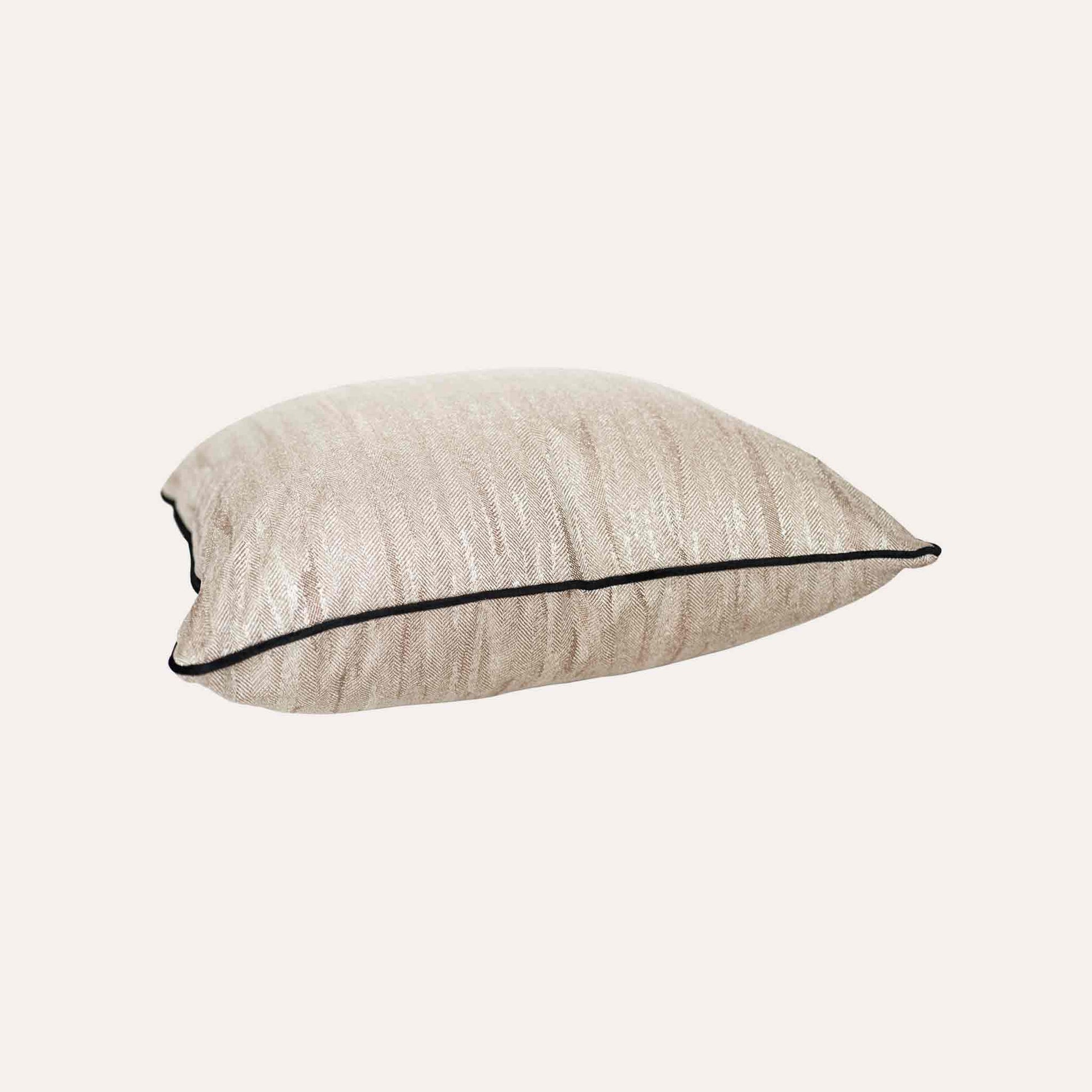 Beige cushion cover with a chic black border, made from cotton linen textured fabric.