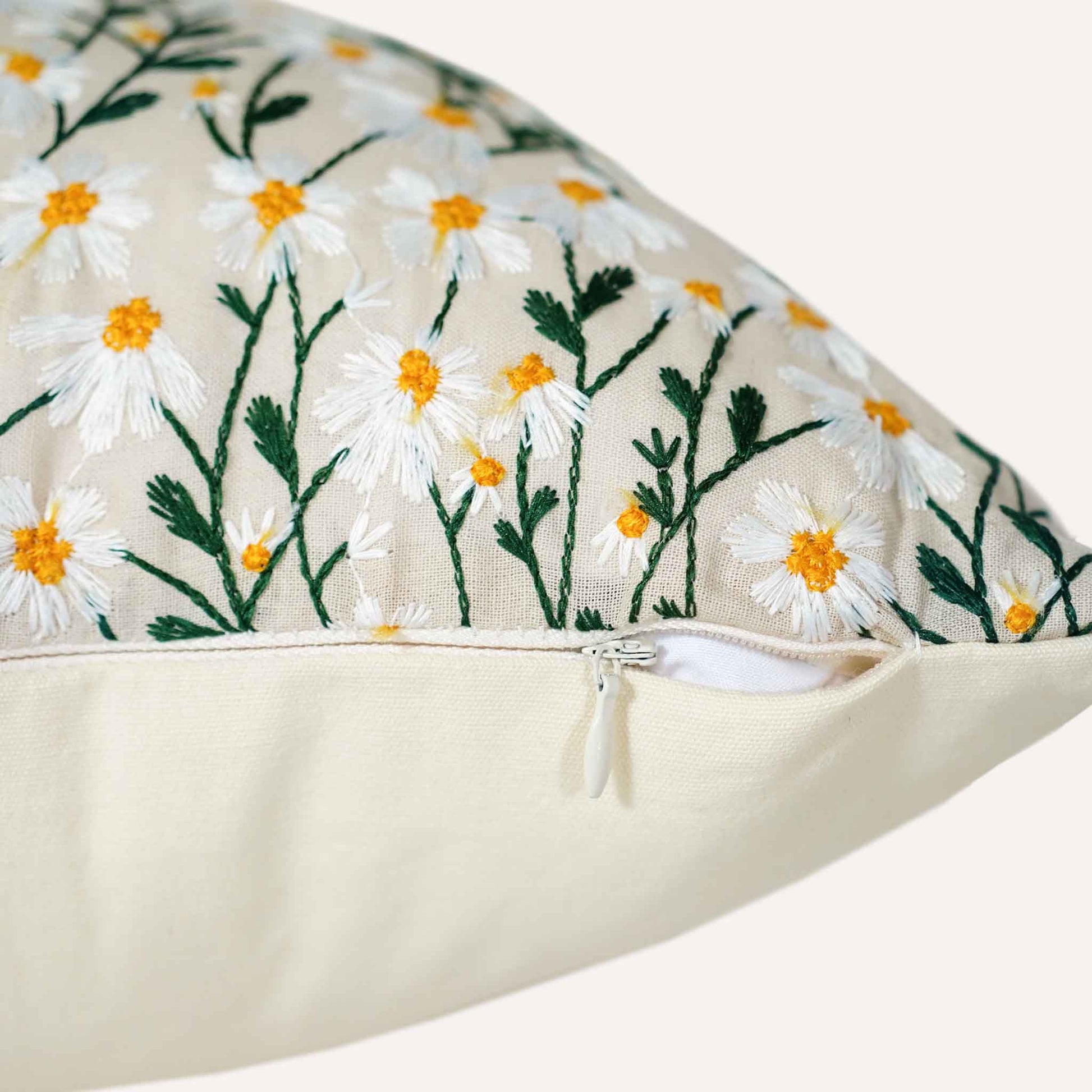 Close-up of the invisible zip on the small daisy beige base cushion.