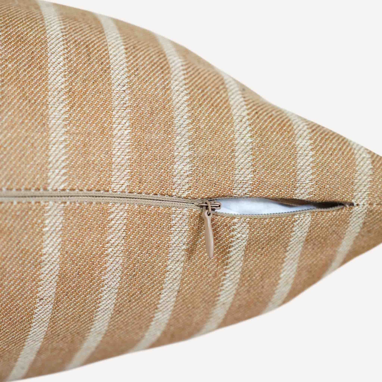 Close up of the invisible zip on the earthy yellow and white striped cushion.