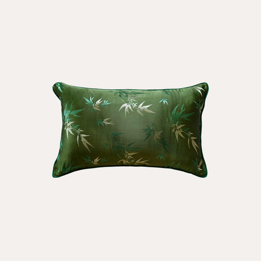 Decorative green cushion cover adorned with golden bamboo leaf design.