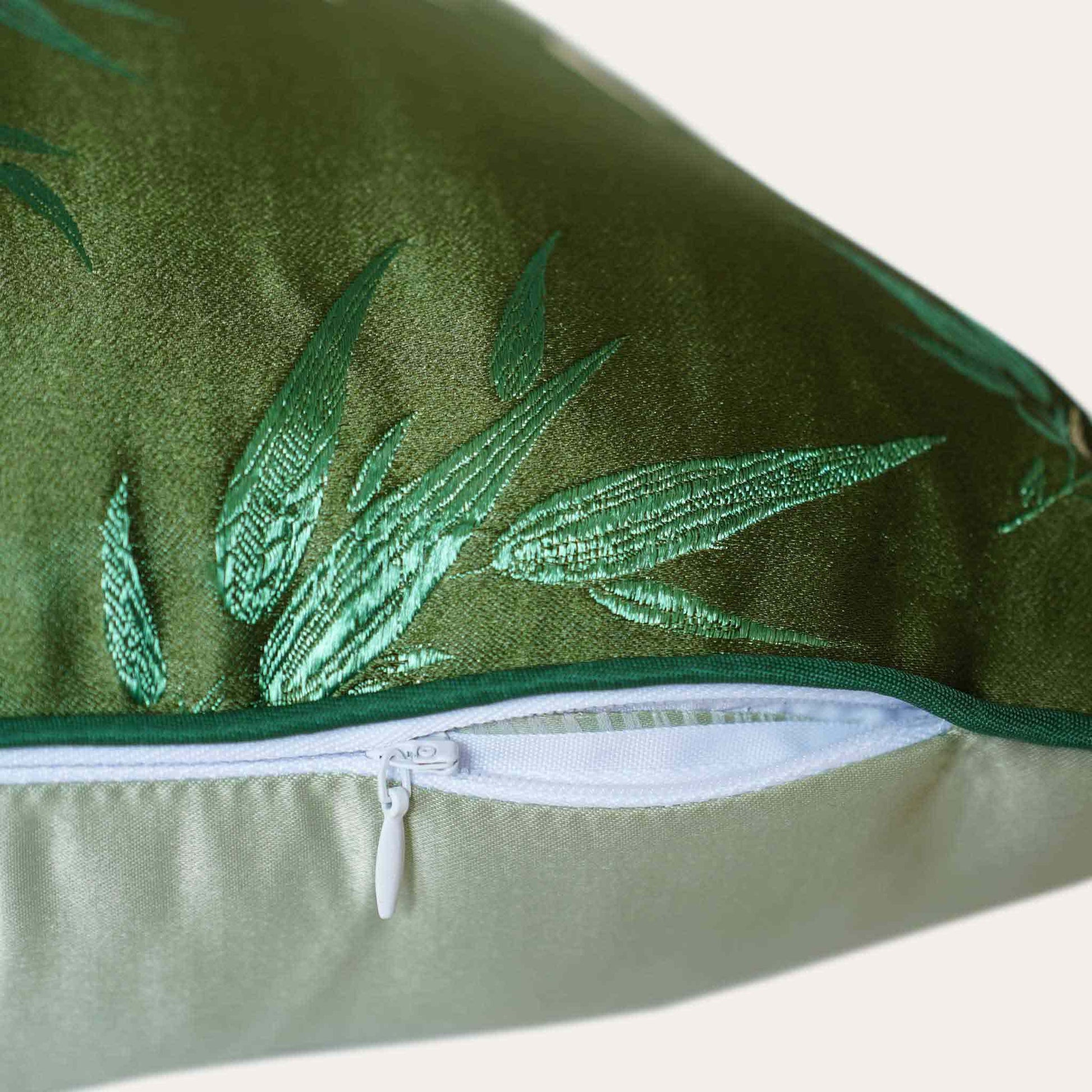 Decorative green cushion cover with gold bamboo leaf pattern with invisible zipper.