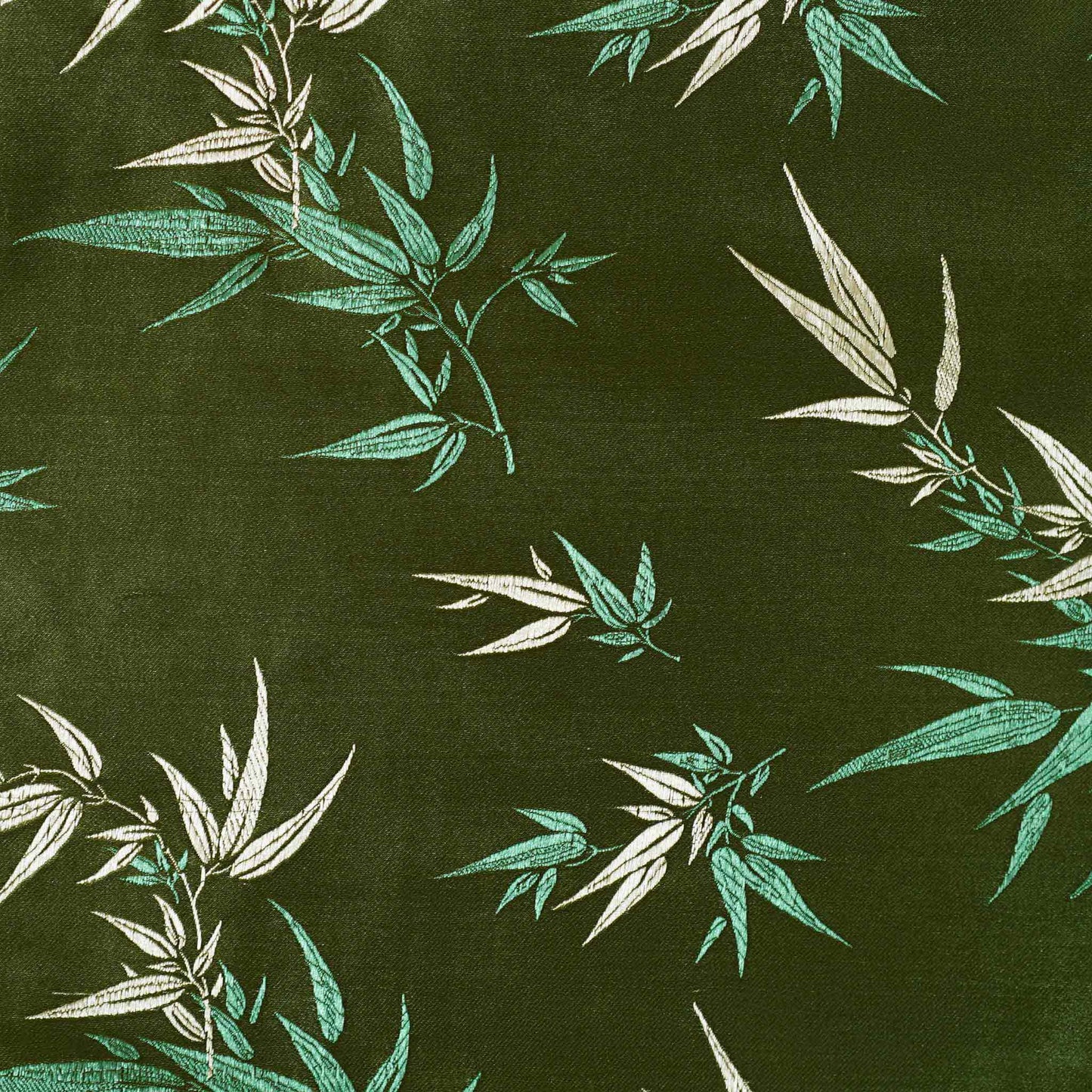 Decorative green cushion cover with gold bamboo leaf pattern embroidery on the fabric.
