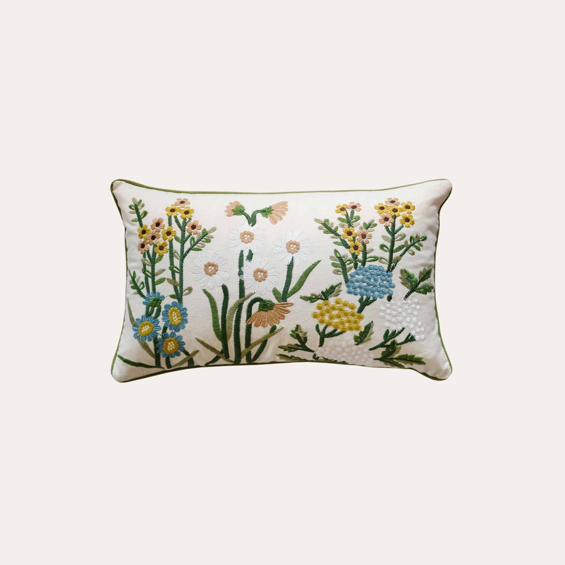 Decorative cushion cover with colorful embroidered floral pattern on a white background.