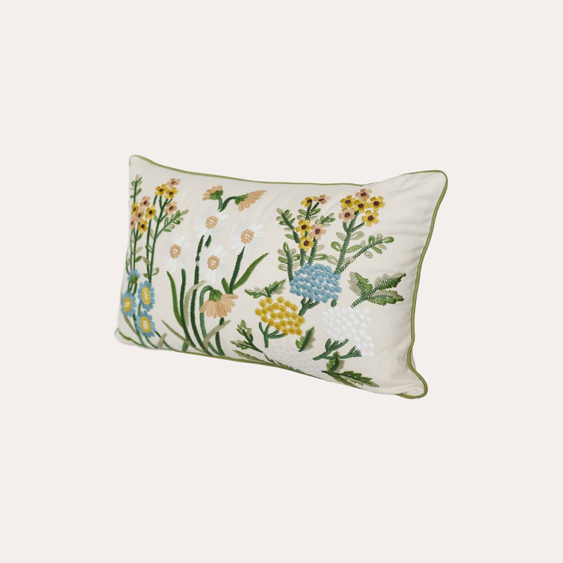 Decorative cushion cover with colorful embroidered floral pattern on a white background.