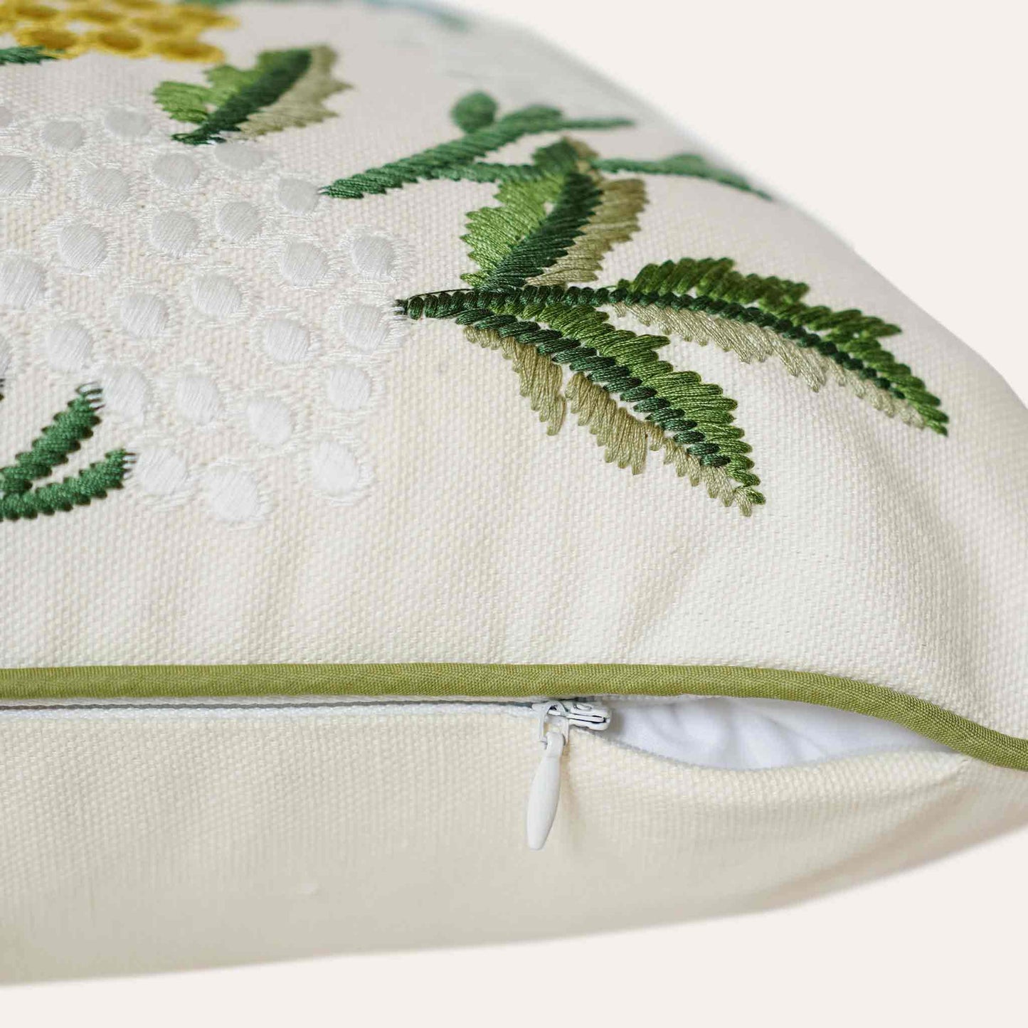 Decorative cushion cover with colorful embroidered floral pattern on white background with invisible zipper.