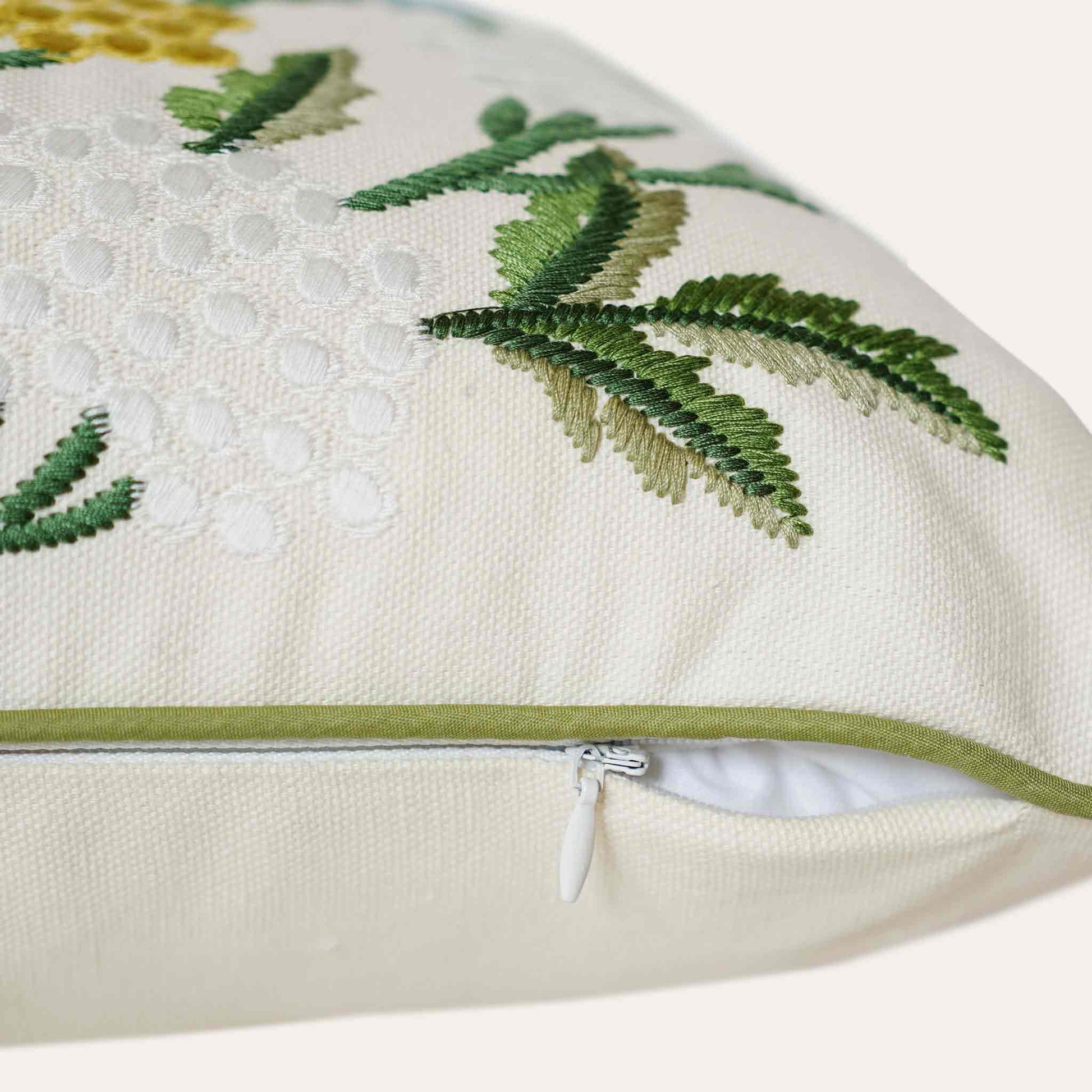 Decorative cushion cover with colorful embroidered floral pattern on white background with invisible zipper.
