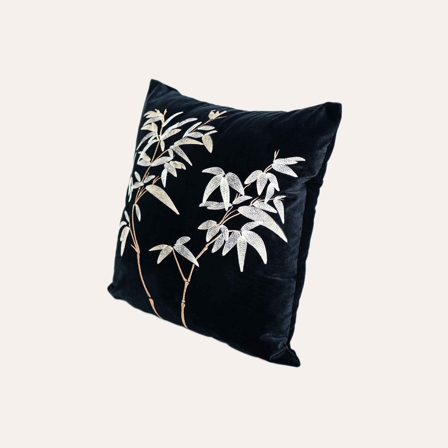 Elegant gold bamboo embroidered cushion cover with black background.