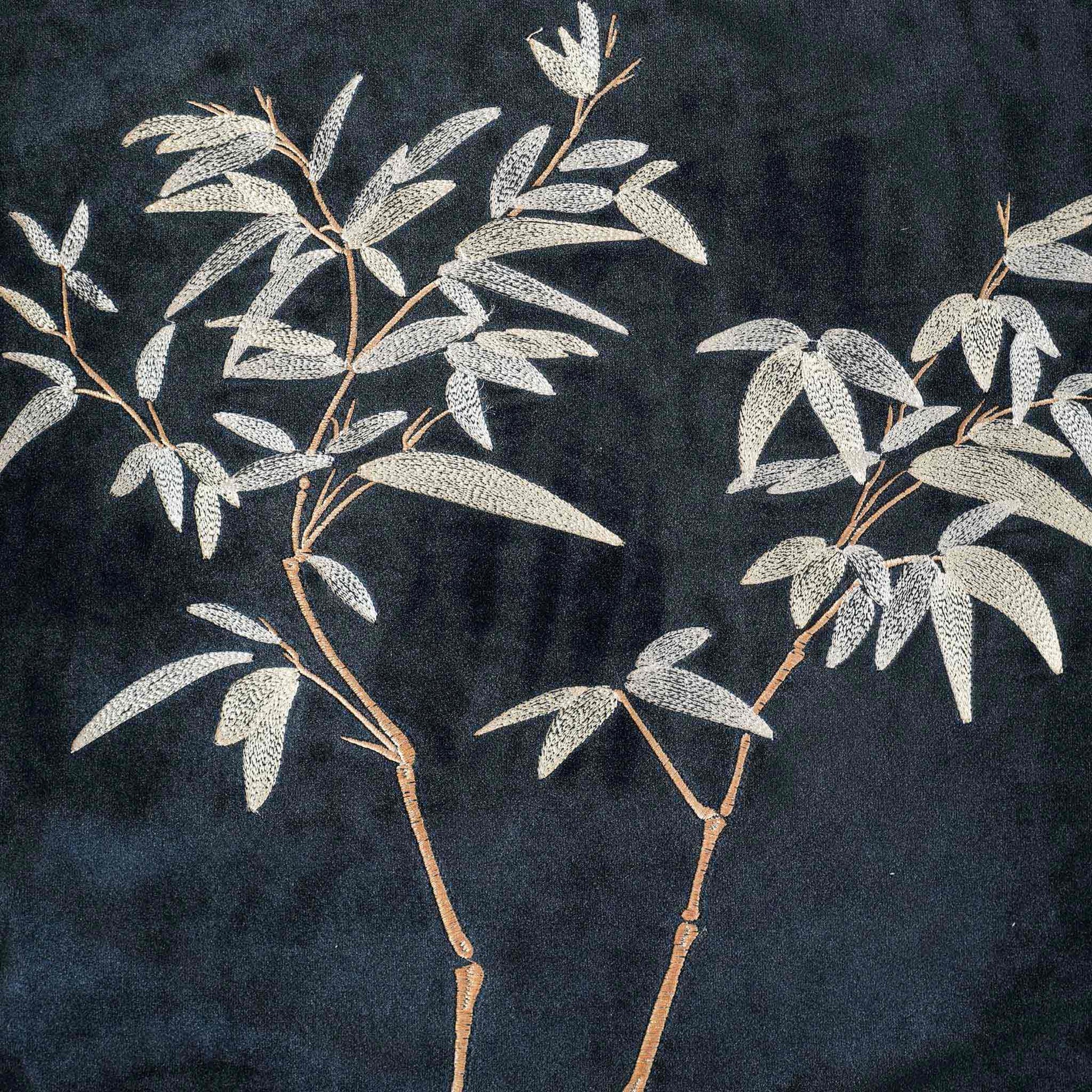 Elegant gold bamboo embroidered cushion cover with black background.