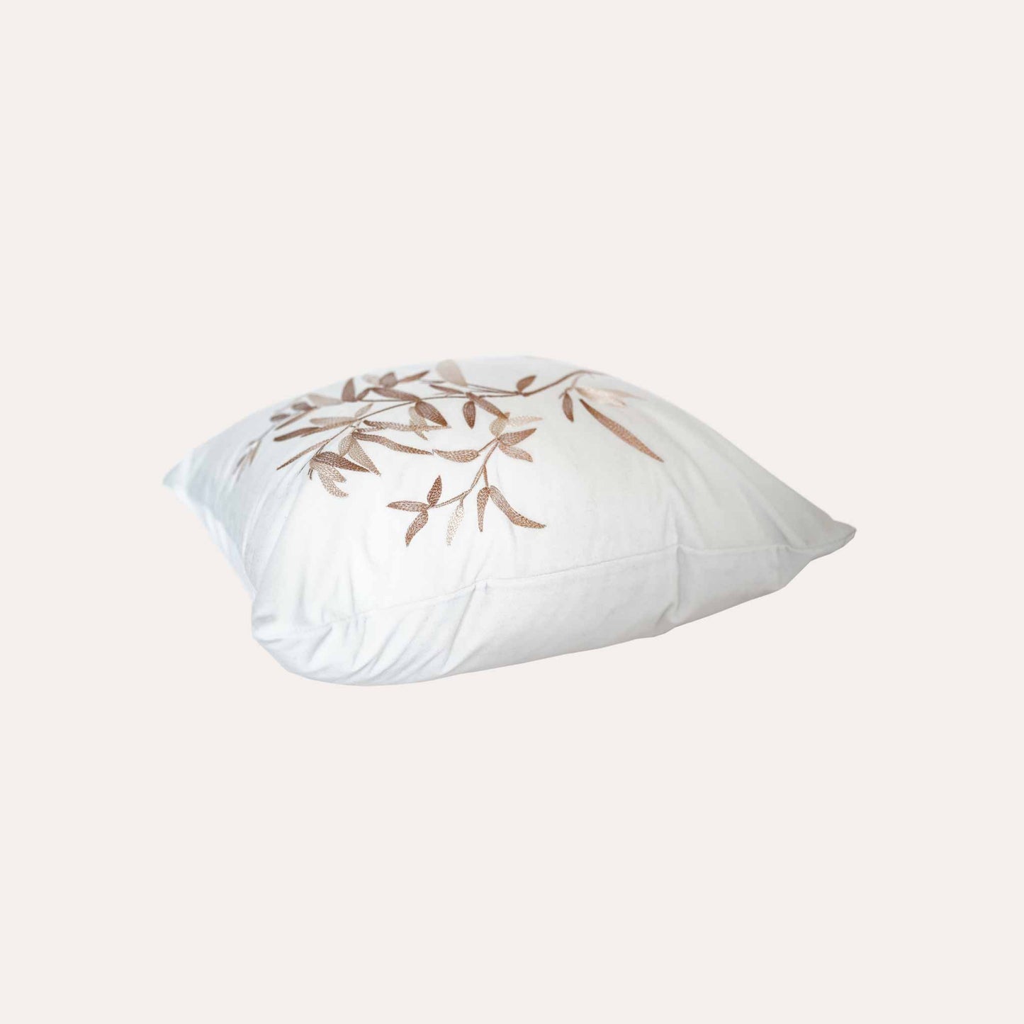 Elegant gold bamboo embroidered cushion cover with white background.