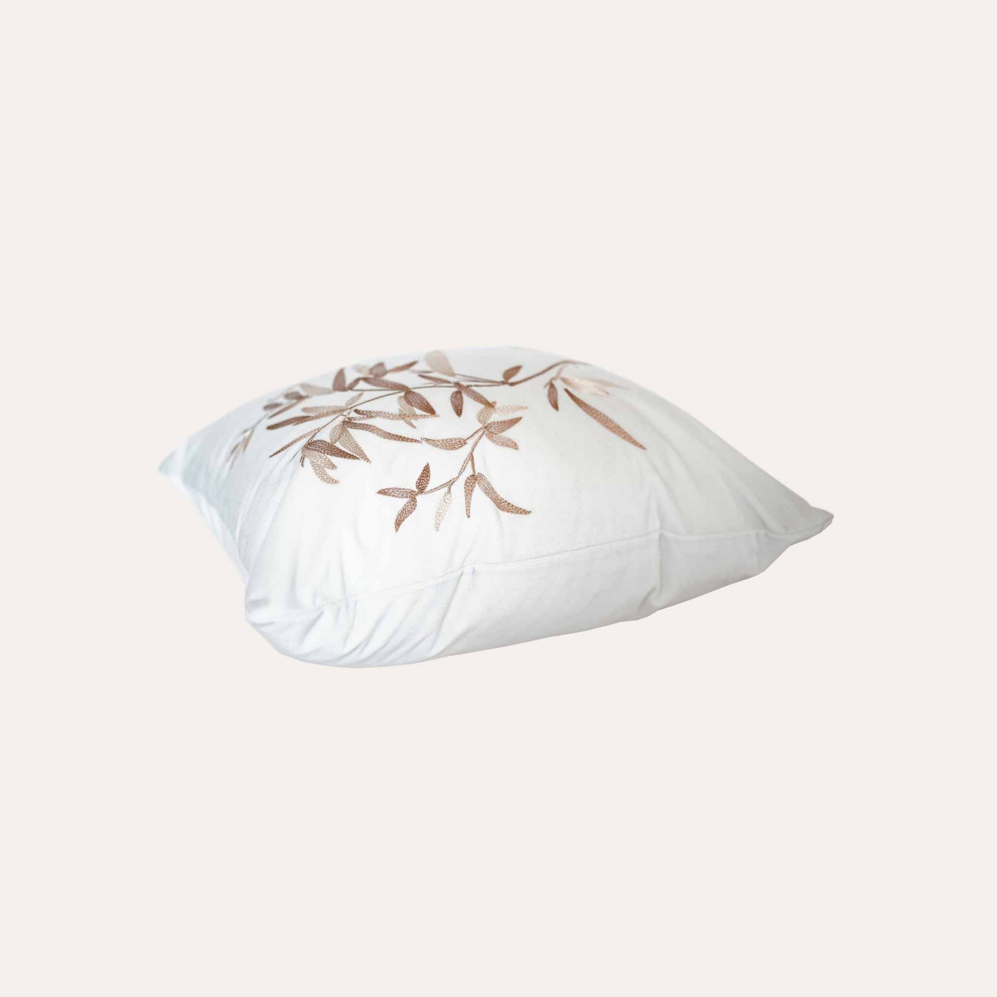 Elegant gold bamboo embroidered cushion cover with white background.