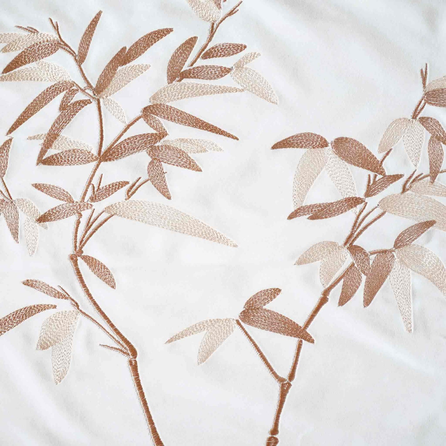 Elegant gold bamboo embroidered cushion cover with white background.