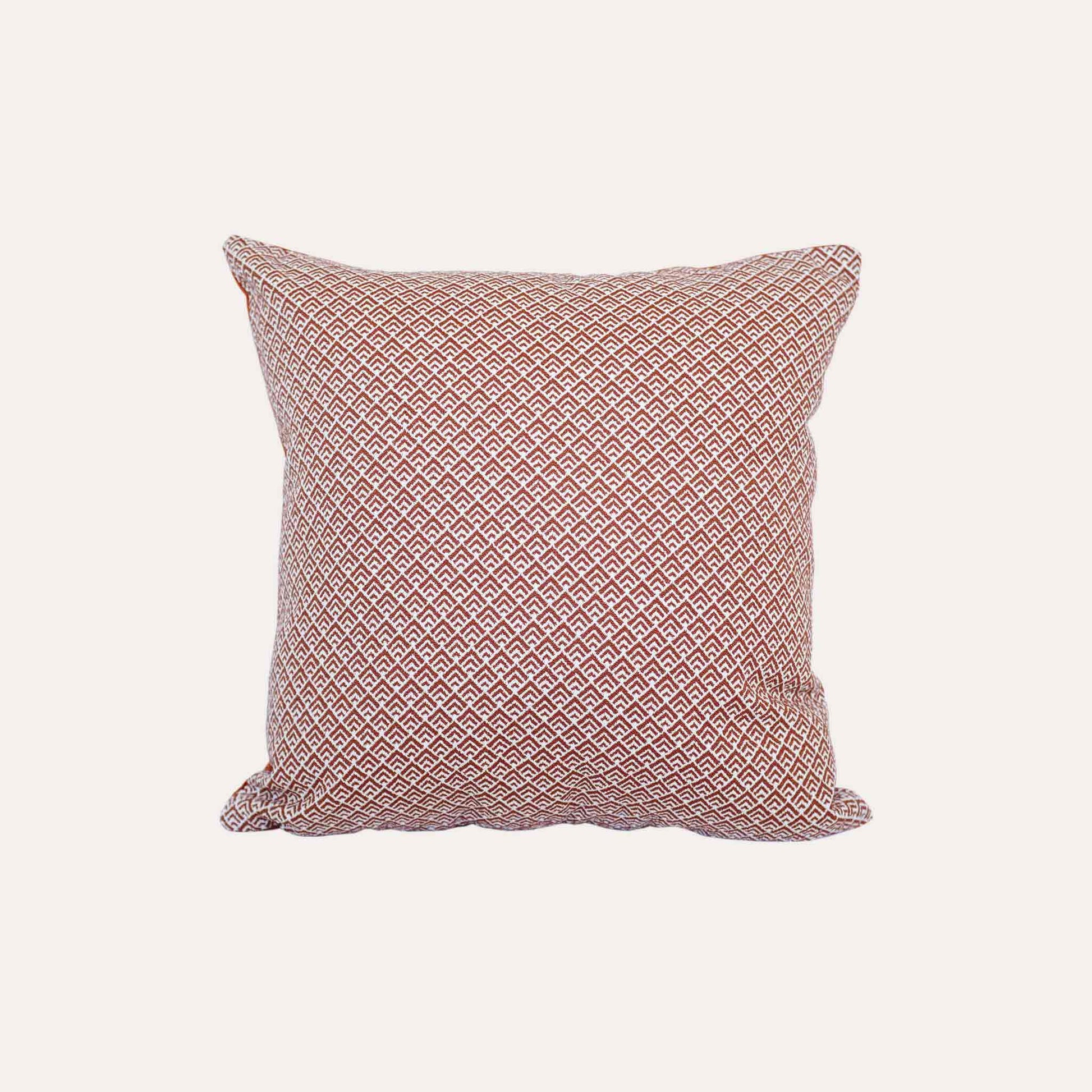 Geometric design cushion covers in red and white chenille fabric.