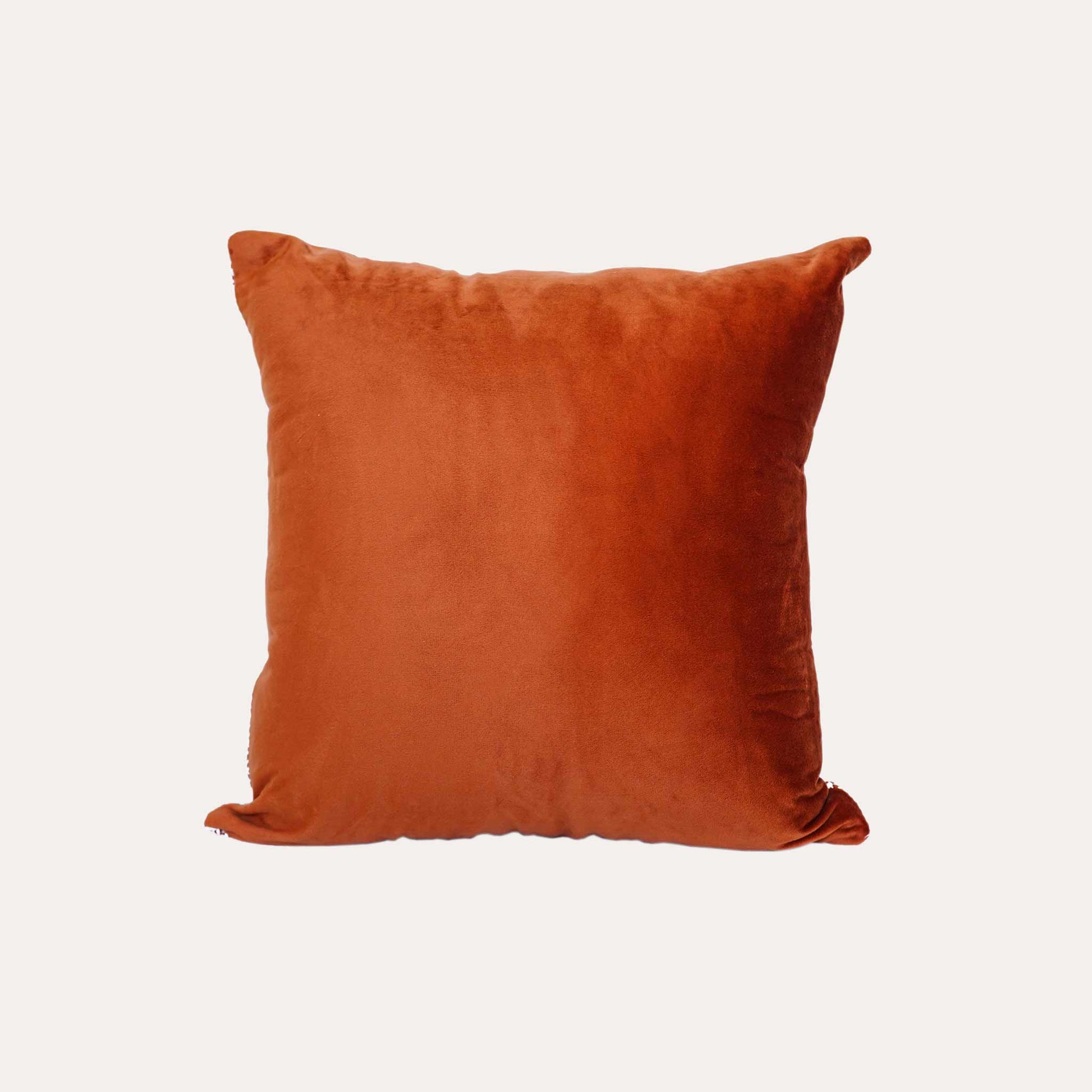 Geometric design cushion covers in red and white chenille fabric with solid orange back.