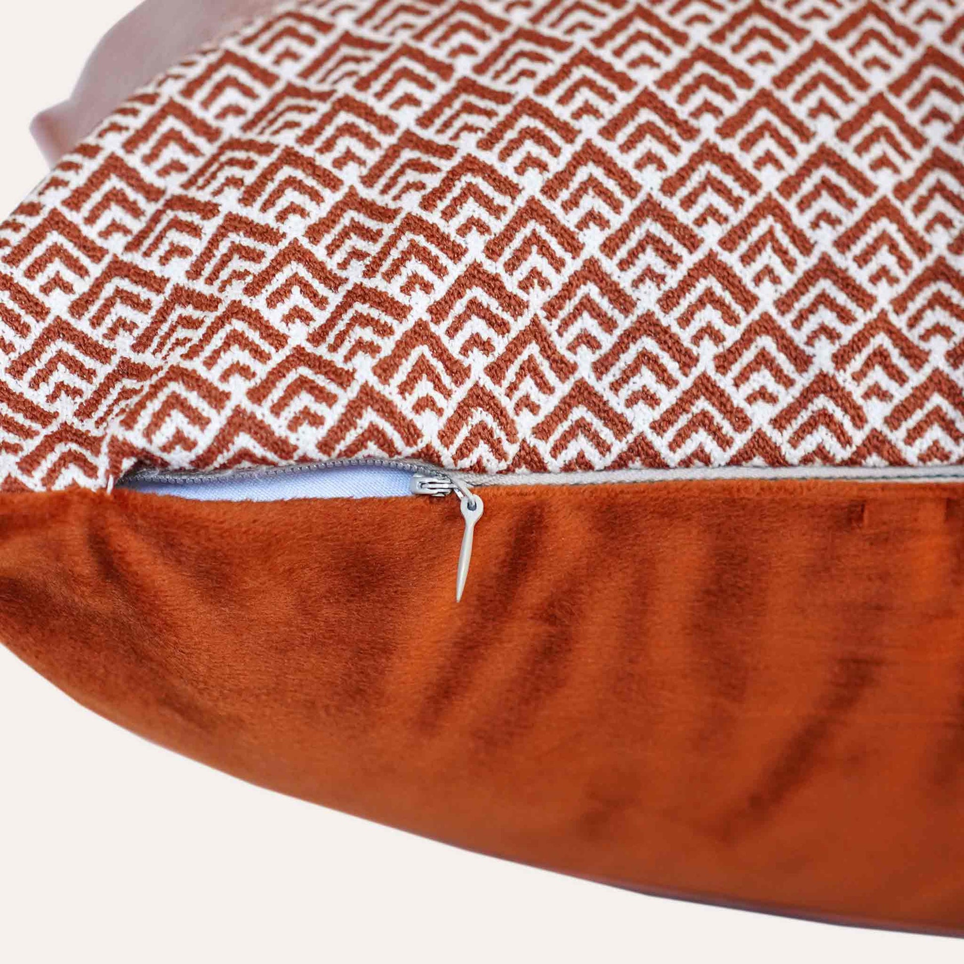 Geometric design cushion covers in red and white chenille fabric with invisible zipper.