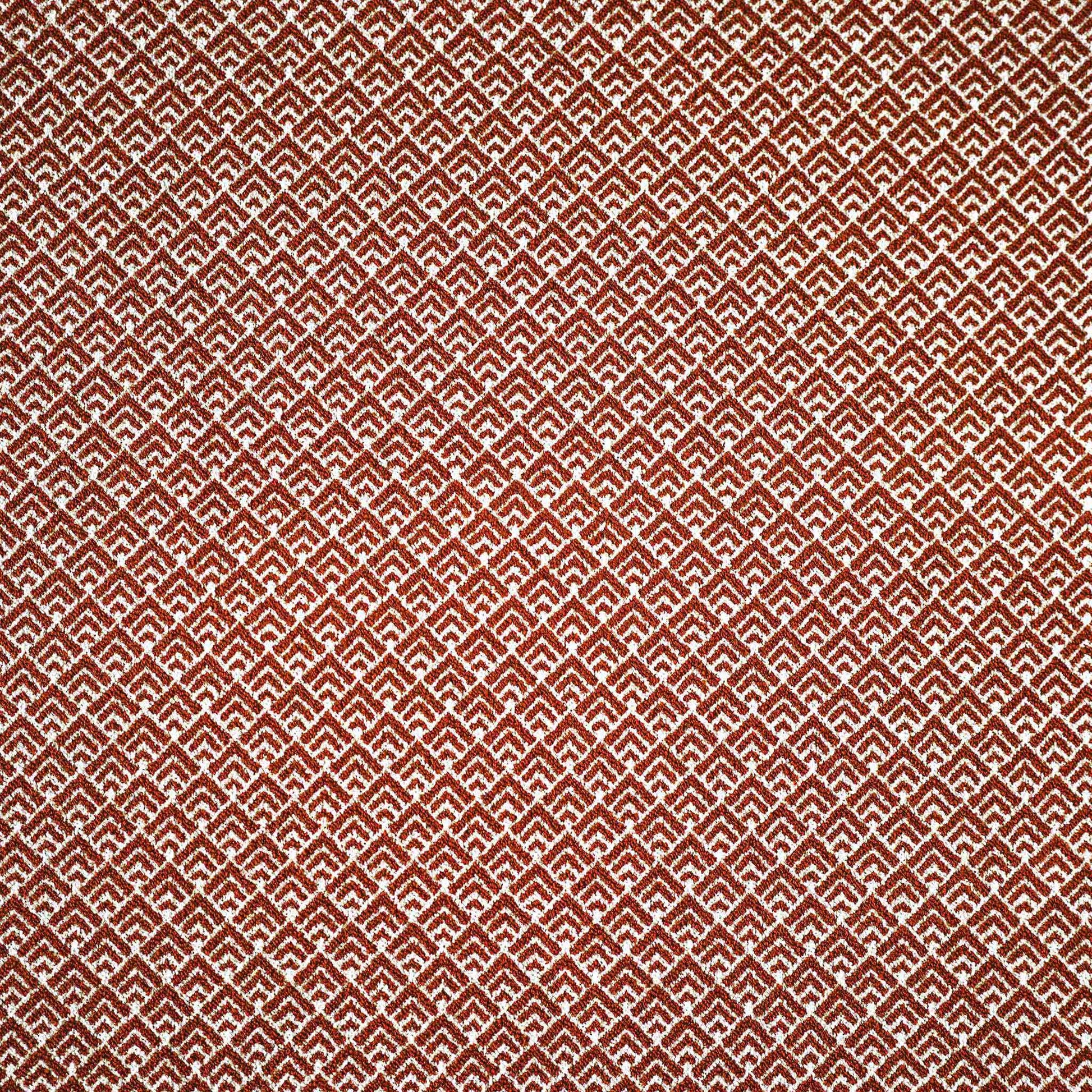 Geometric design cushion covers in red and white chenille fabric.