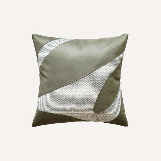 A decorative cushion cover featuring a green and grey irregular splicing design.